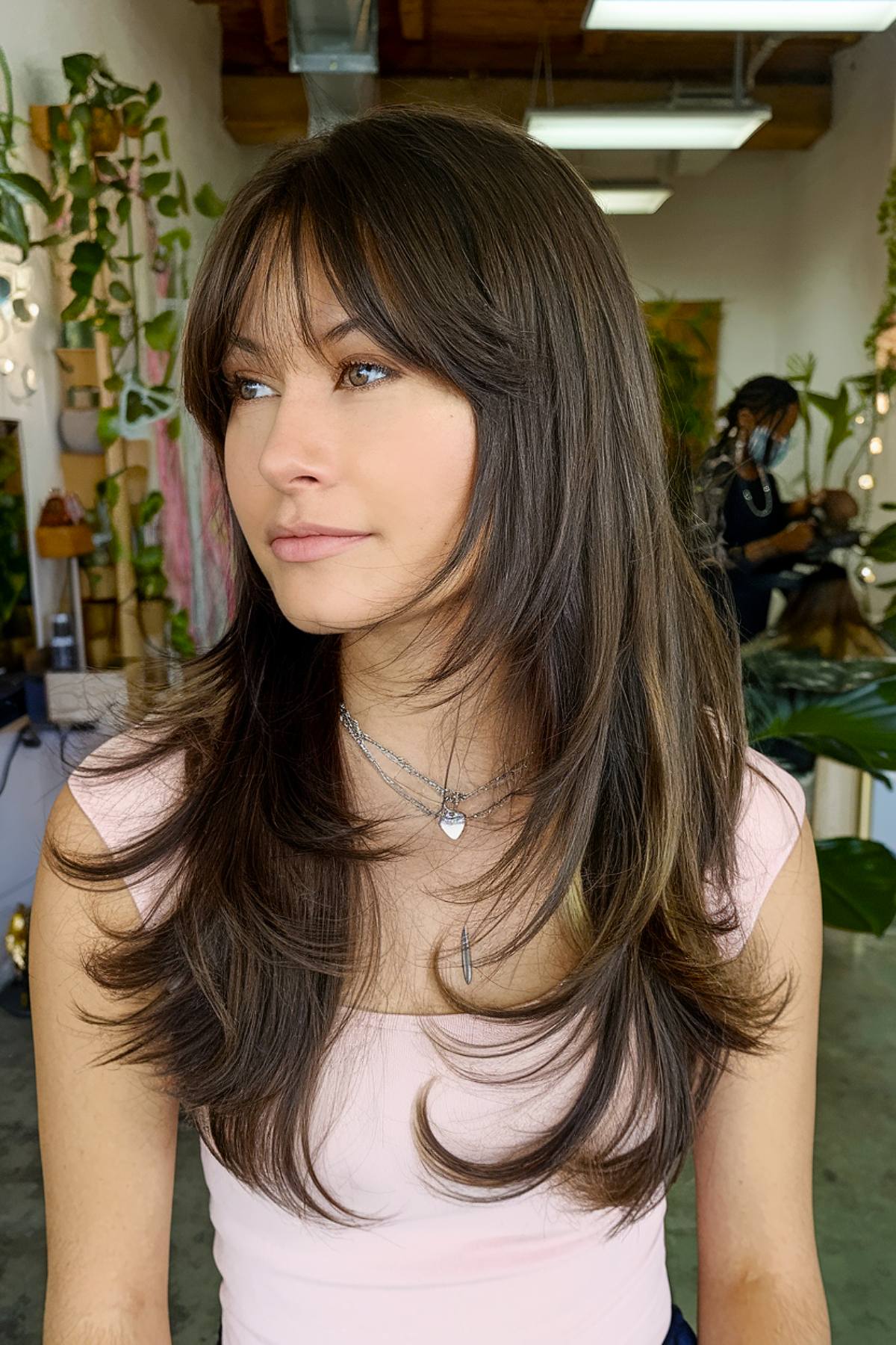 Long straight brown hair with curtain bangs