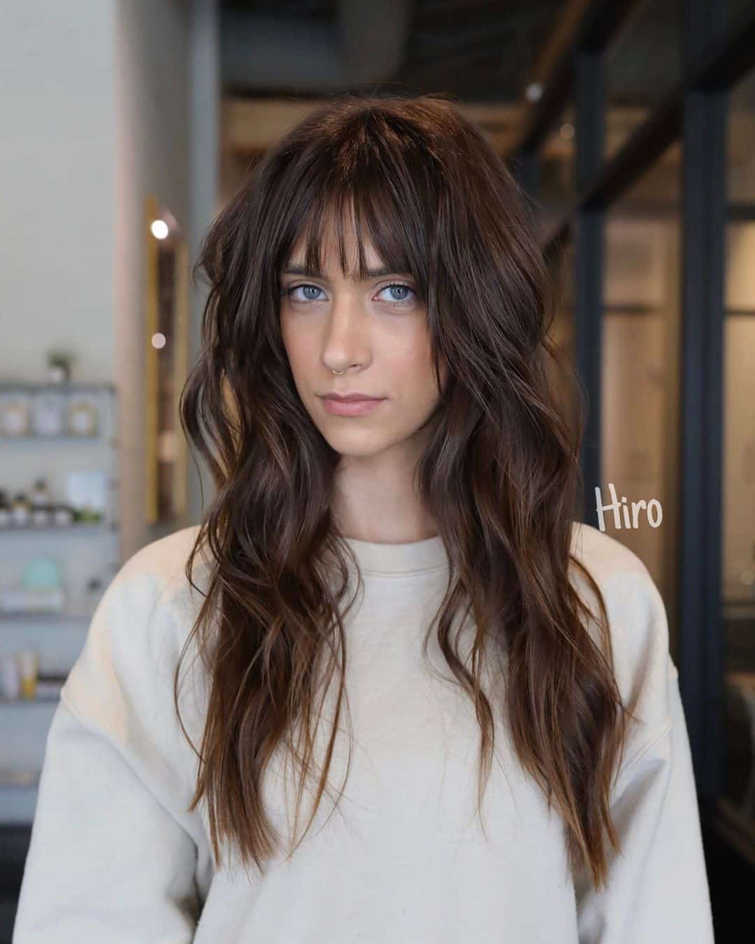long textured layered hair with wispy bangs
