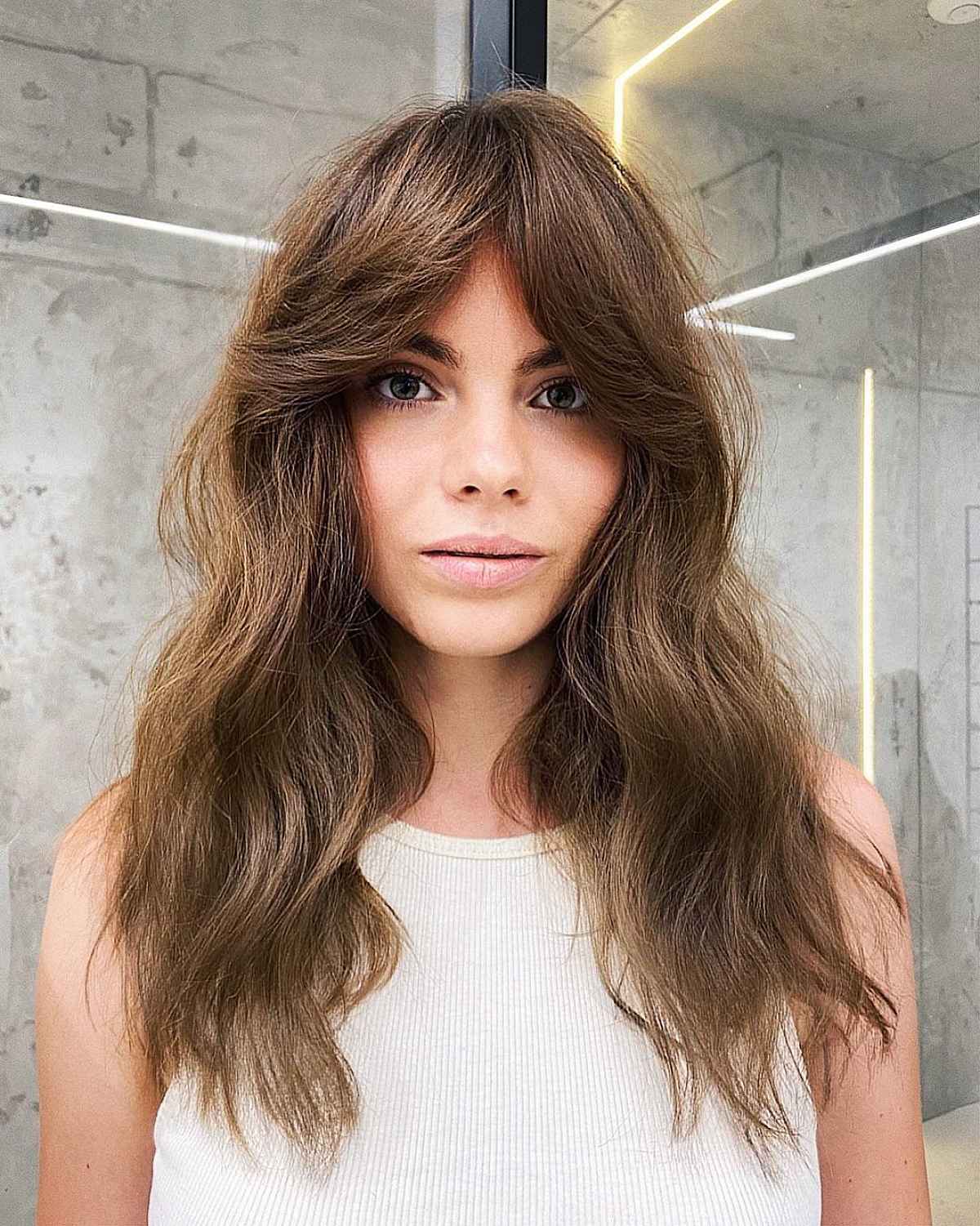 Long Wavy Haircut with Parted Bangs