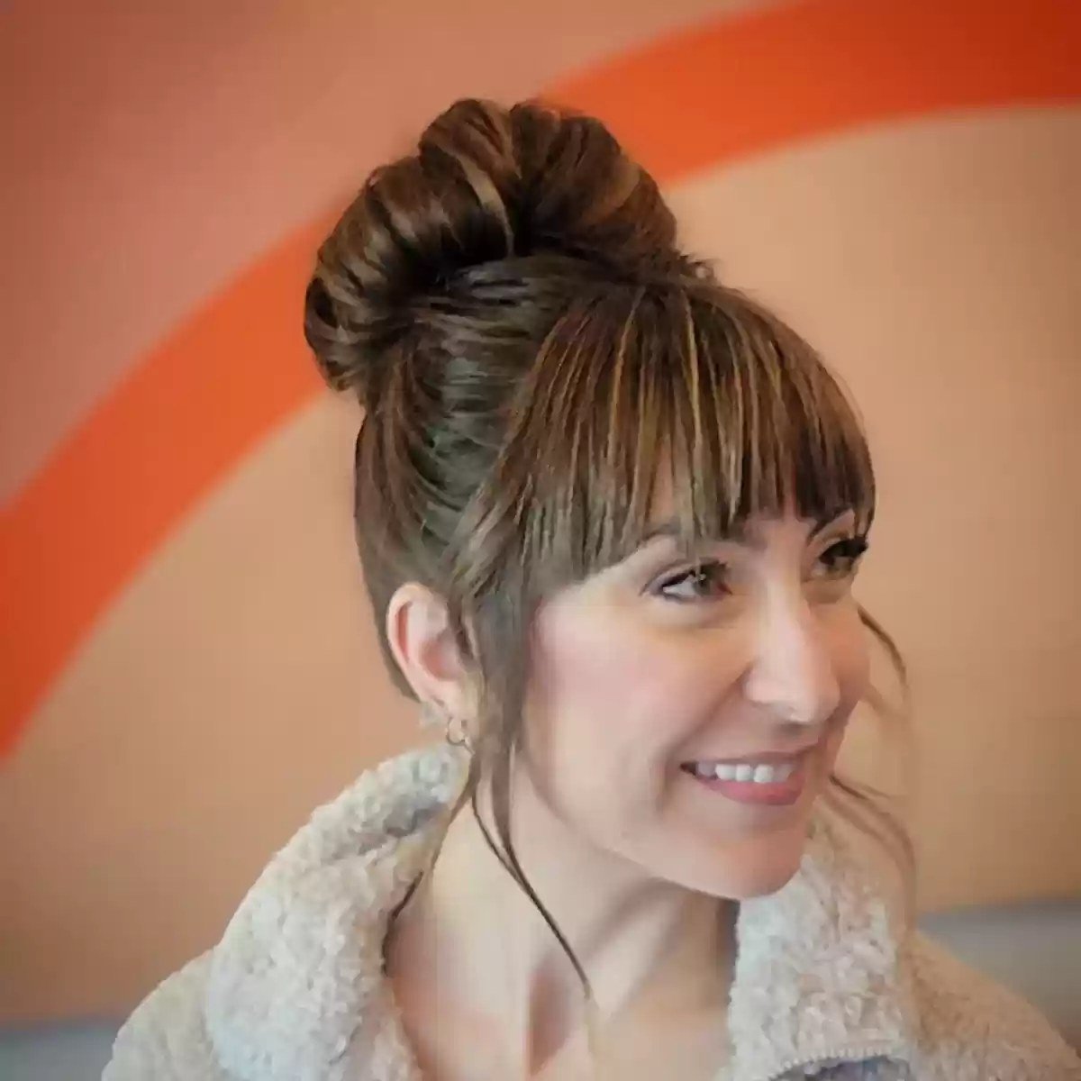 Loose Bun Updo Style with Full Bangs
