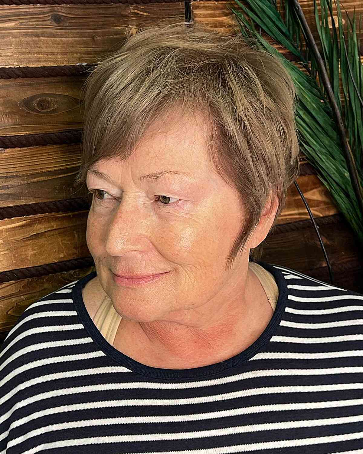Low-Maintenance Pixie with Tousled Layers and Side-Swept Bangs for 60-year-old Ladies