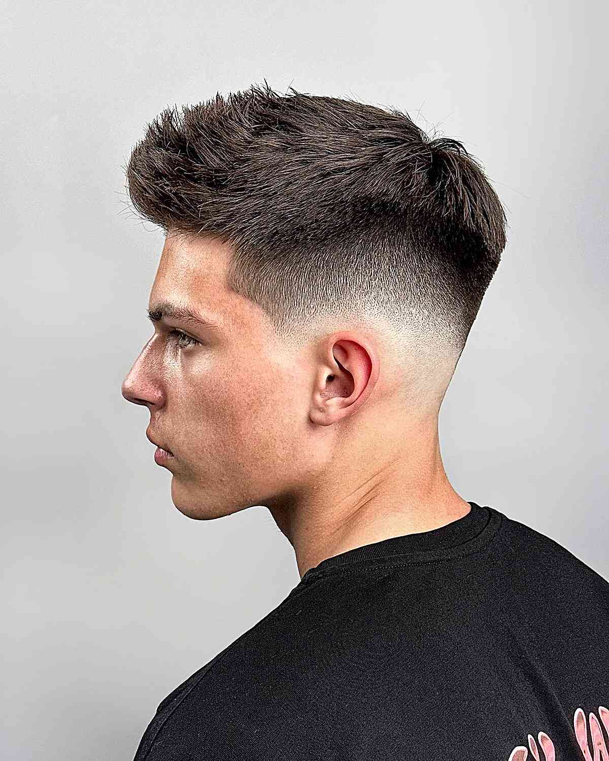 Low Skin Fade with a Messy Quiff Top for Men