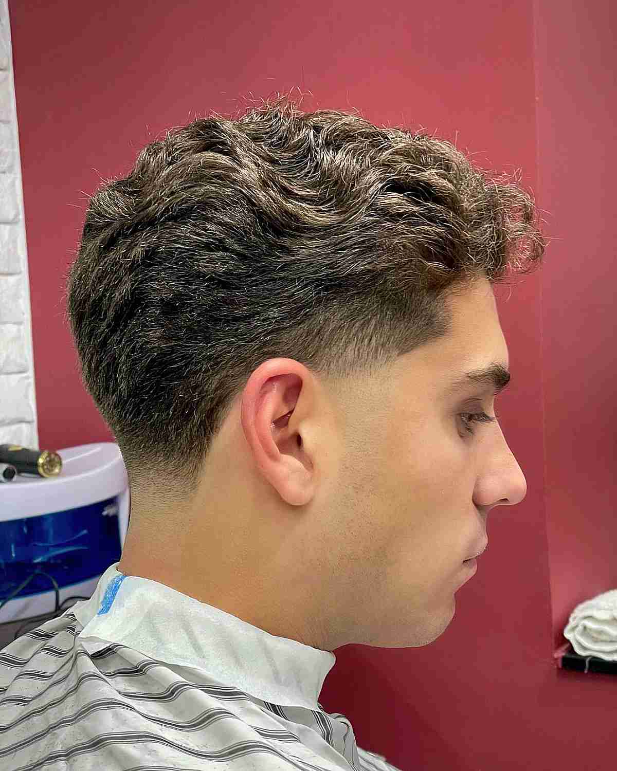 Low Taper Fade and Brushed Back Wavy Hair