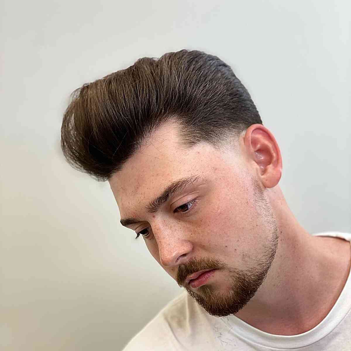 Low Taper Fade with Classic Pompadour on Men's Straight Hair