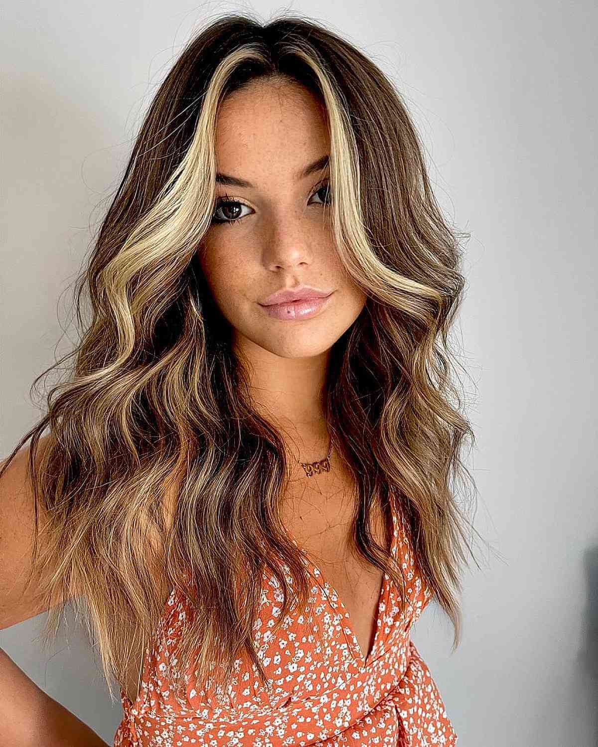 Lowlights on Mid-Length Wavy Brown Hair with a Money Piece