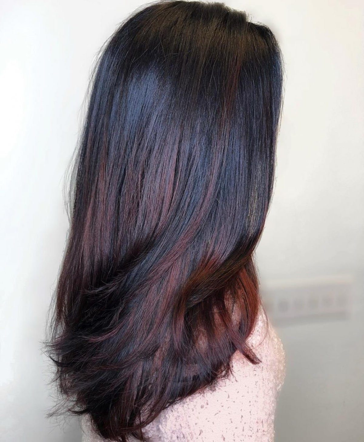 Fashionable mahogany brown highlights on long black hair