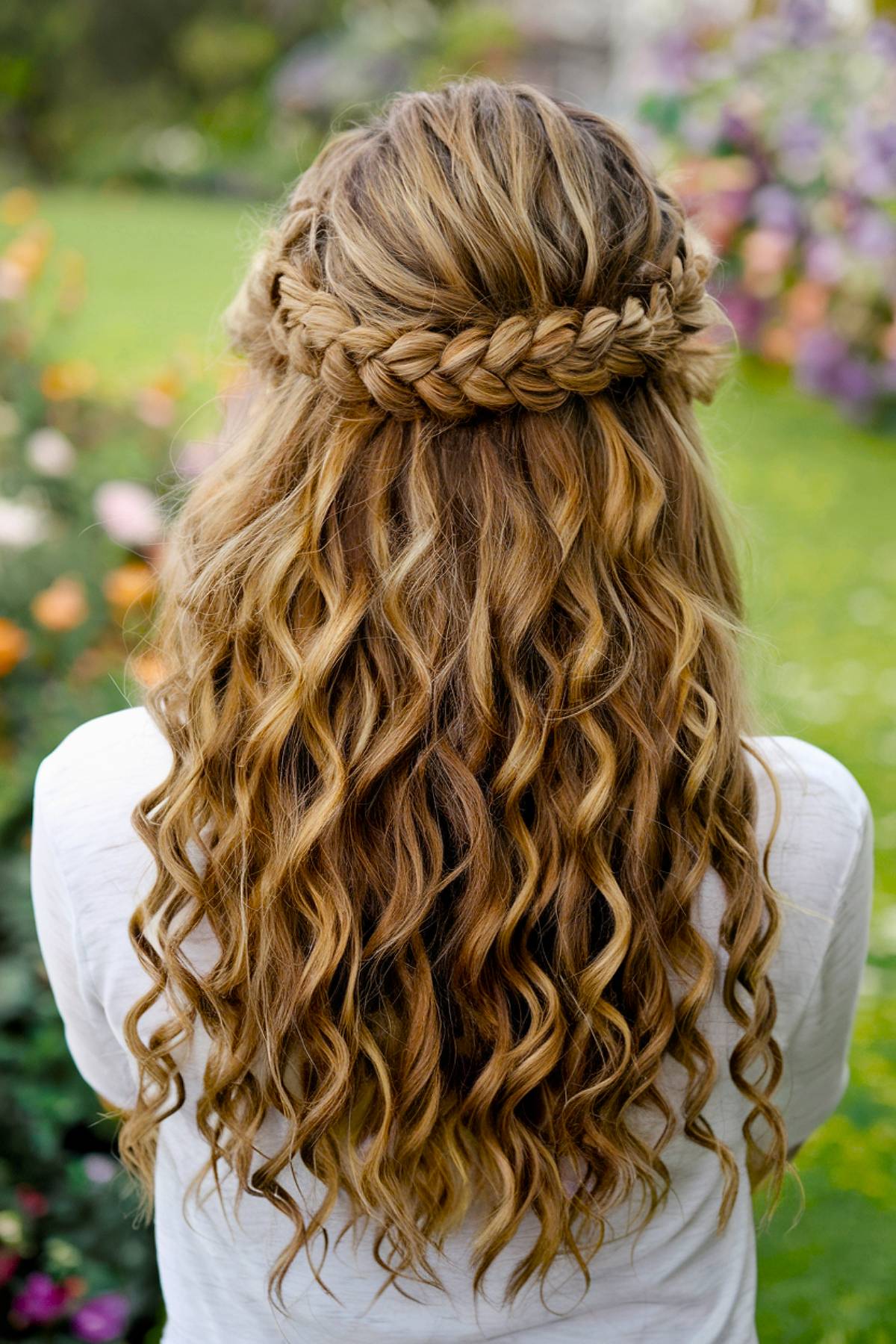 Intricate braided crown with long, textured waves, blending bohemian charm with regal elegance