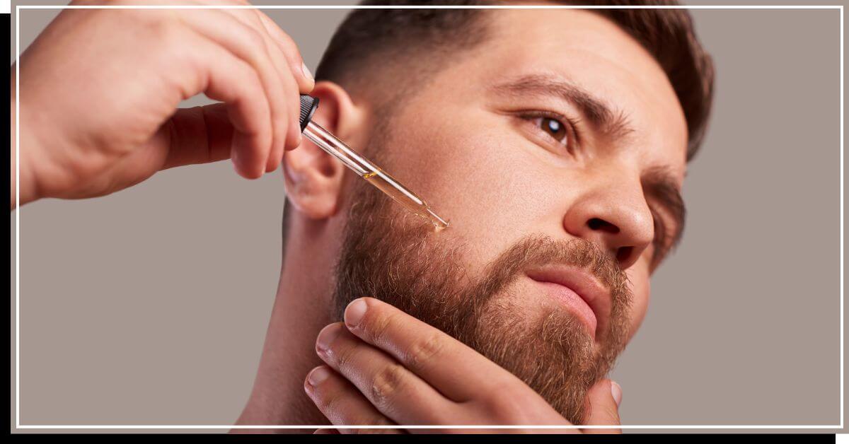 Man applying oil on beard and mustache