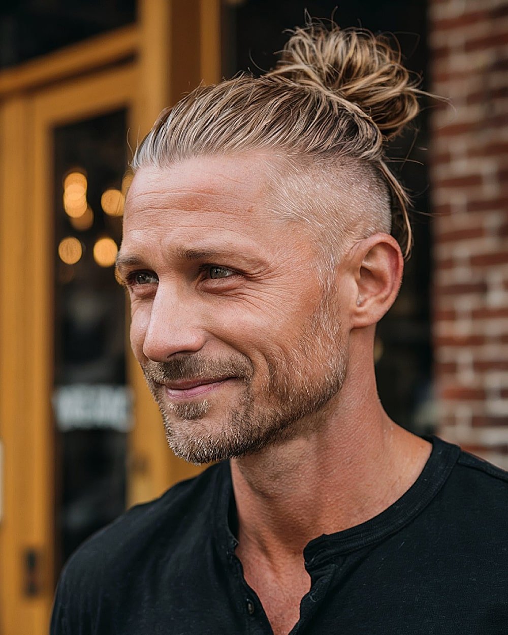 Man bun with high undercut and slicked back top for men
