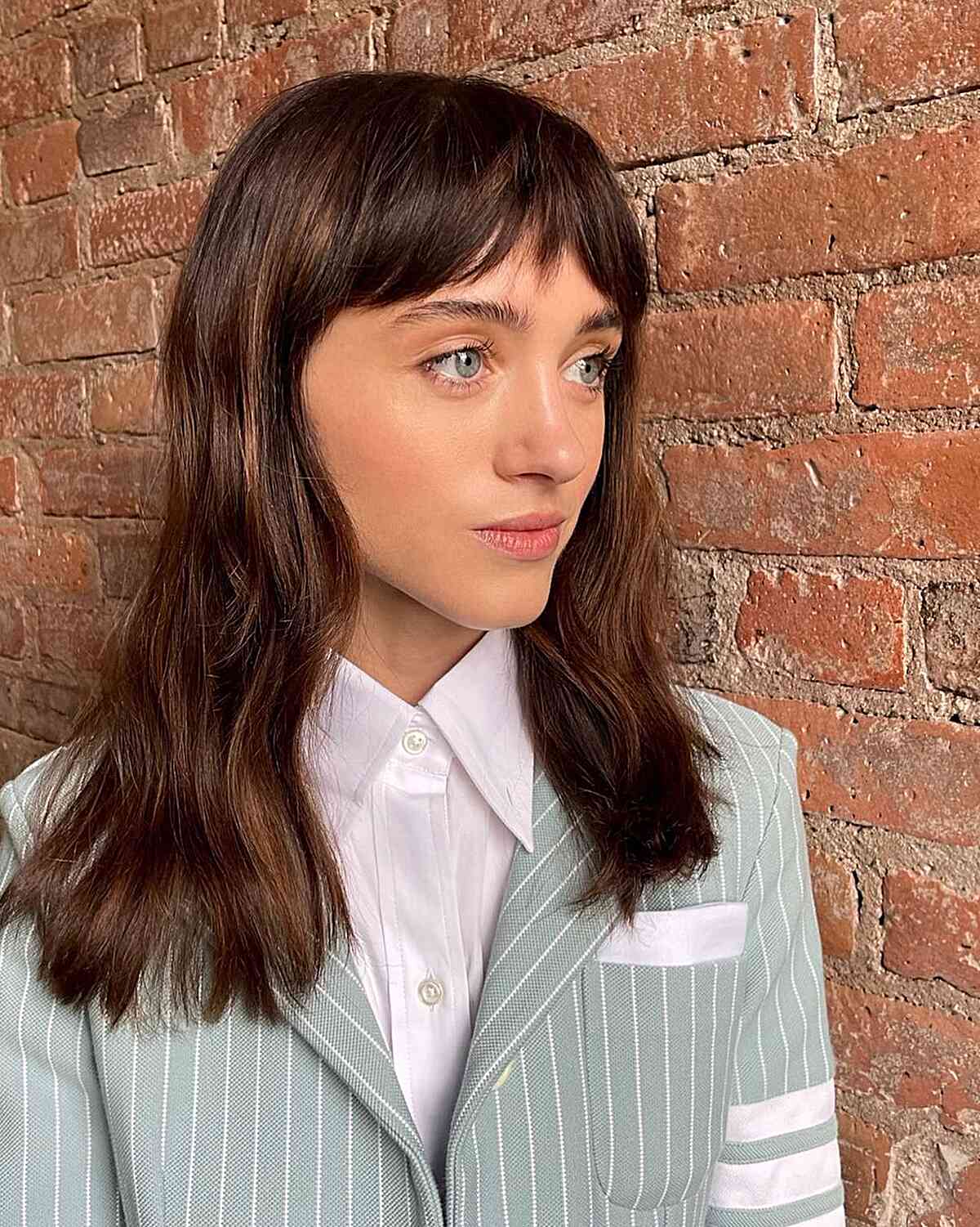 Medium Brunette Wavy Hair with French Curtain Bangs
