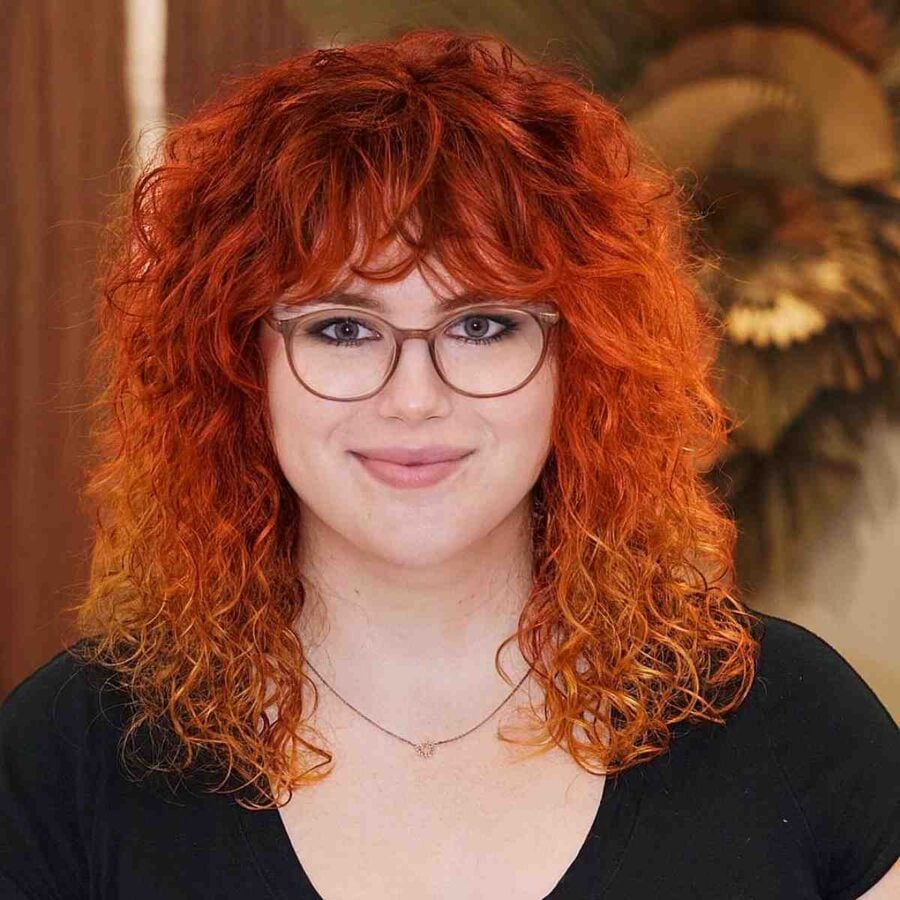 Medium Curly Shag with Bangs to Make Round Faces Appear Longer