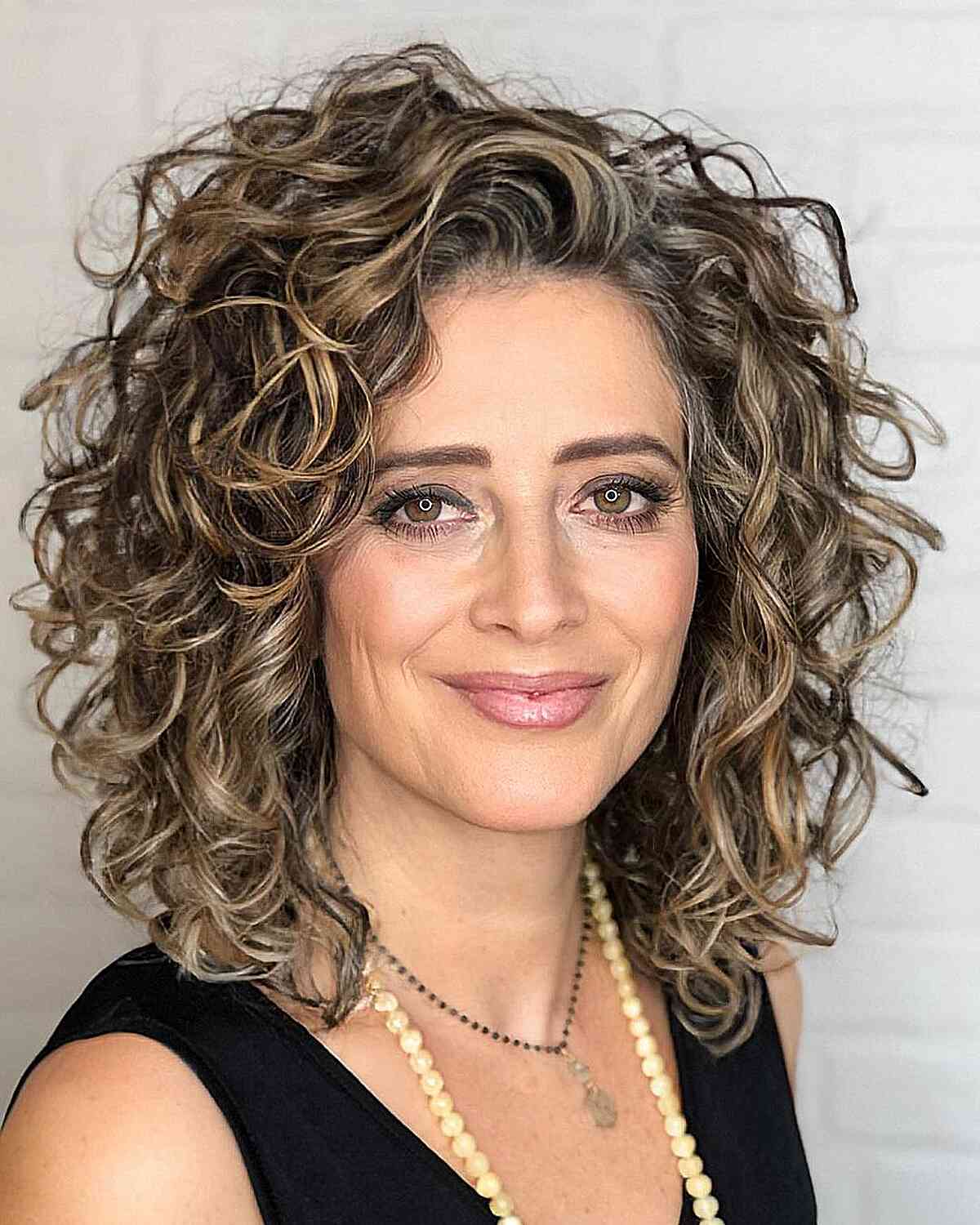 Medium Gorgeous Natural Curls with Highlights for Women Aged 40
