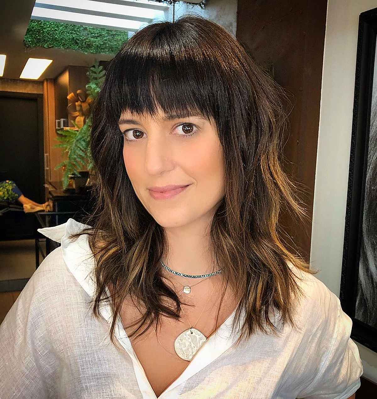 Medium haircut with long shaggy layers with a textured fringe