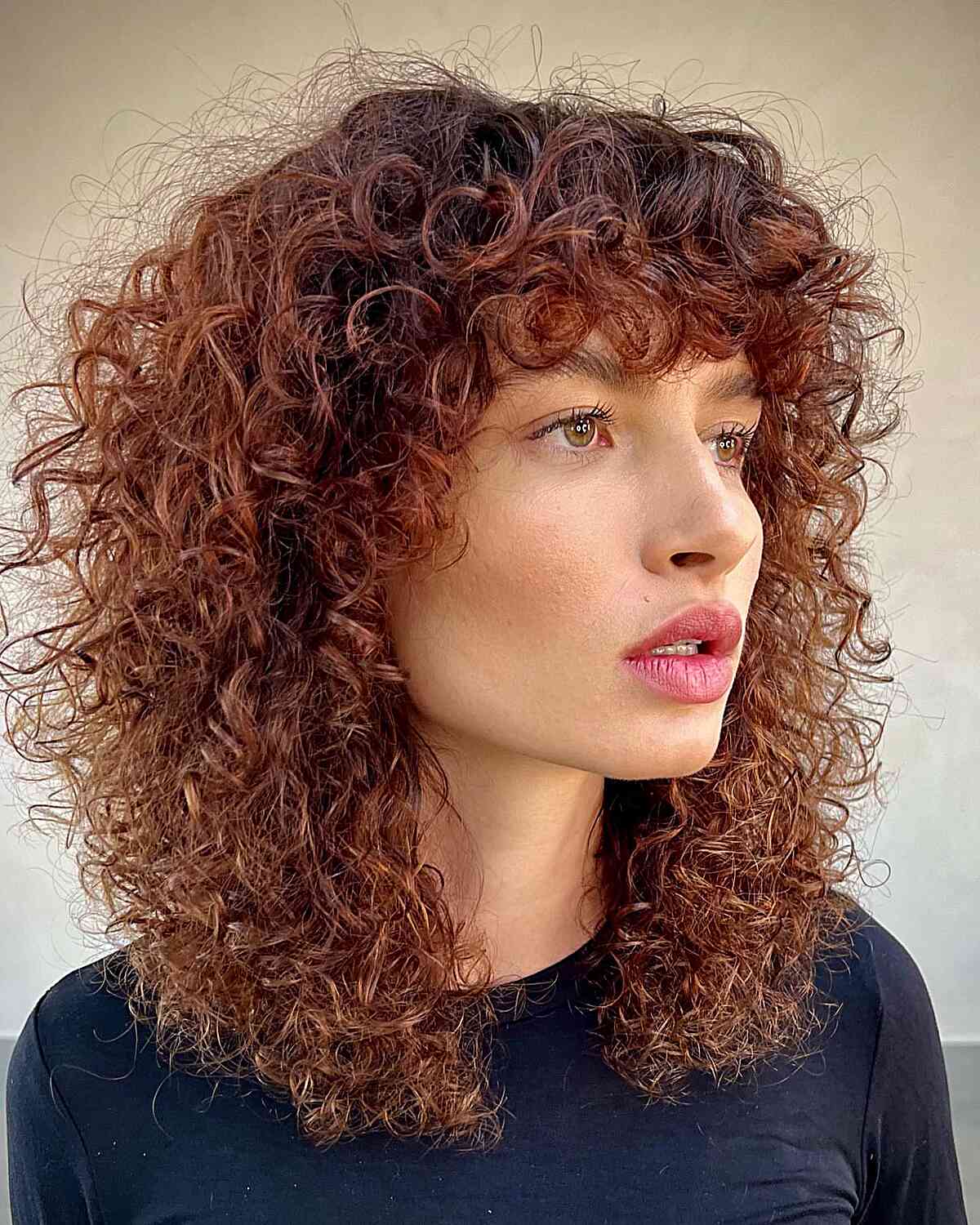 Medium Layered Curls and Concave Bangs for women with a retro style