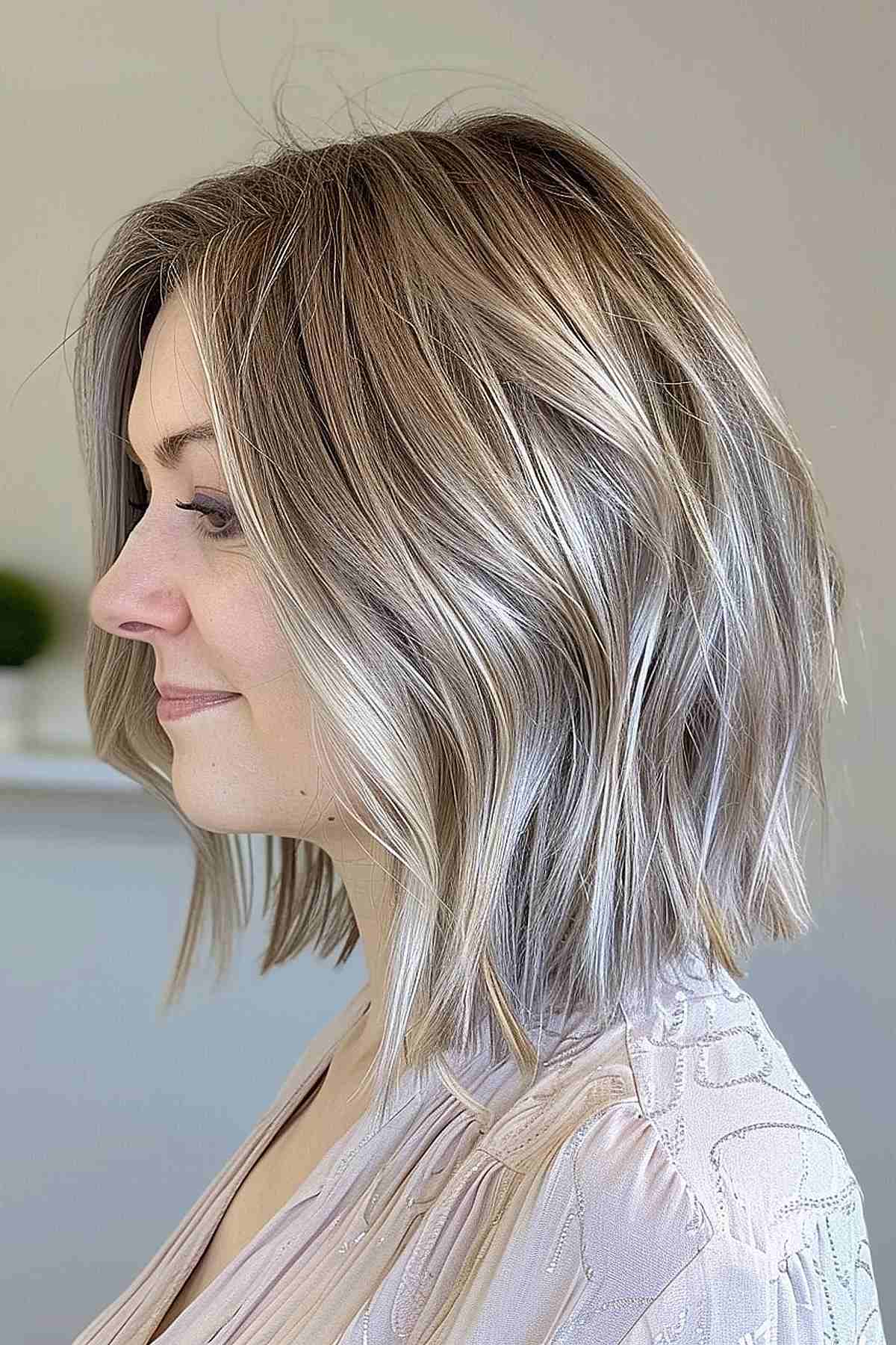Medium-length ashy blonde bob with soft layers and highlights