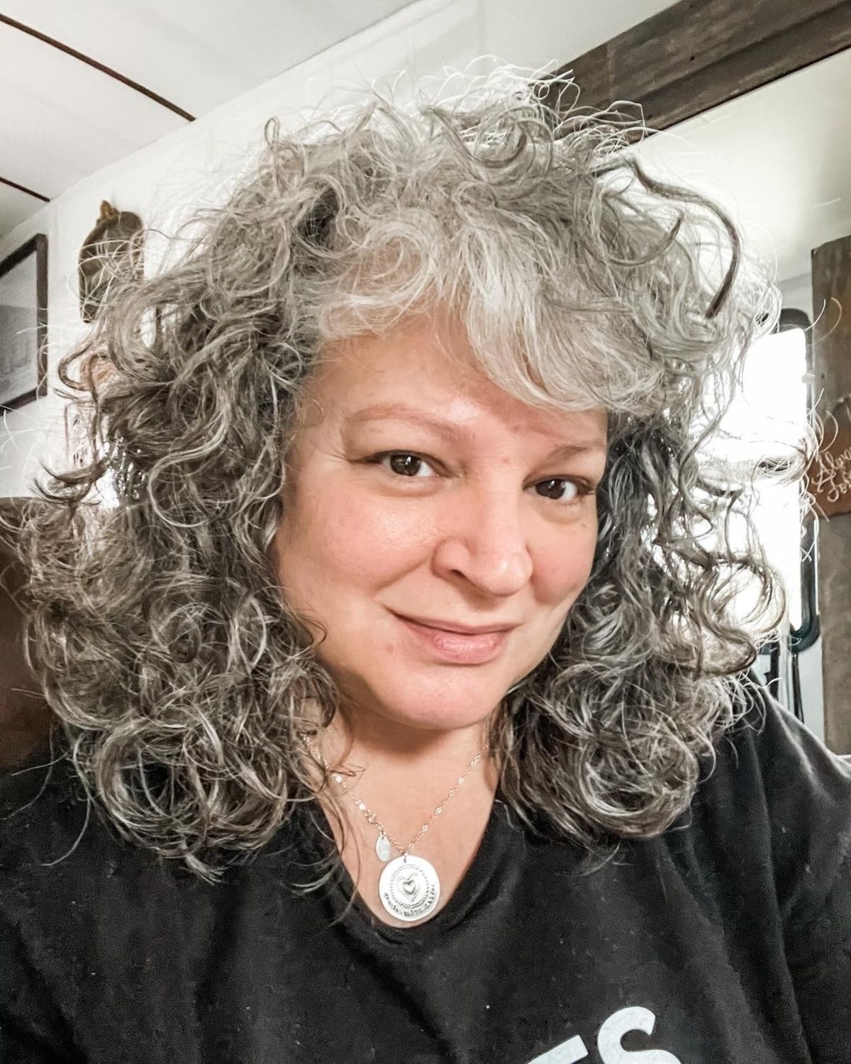 Medium-length cut for women in their fifties with curly hair