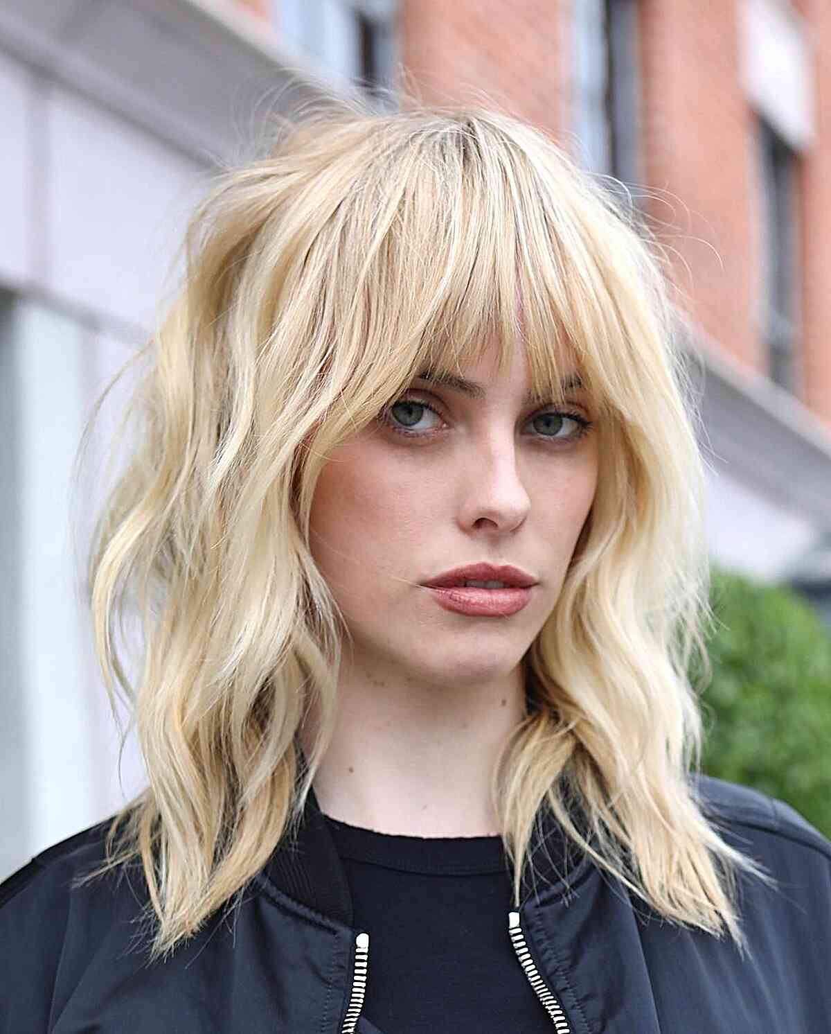 Medium-Length Grunge Shag Cut with Fringe for women with light blonde hair