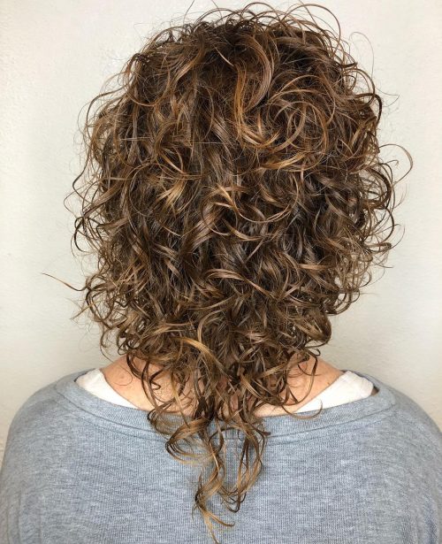 Trendy medium-length curly hair with v-cut