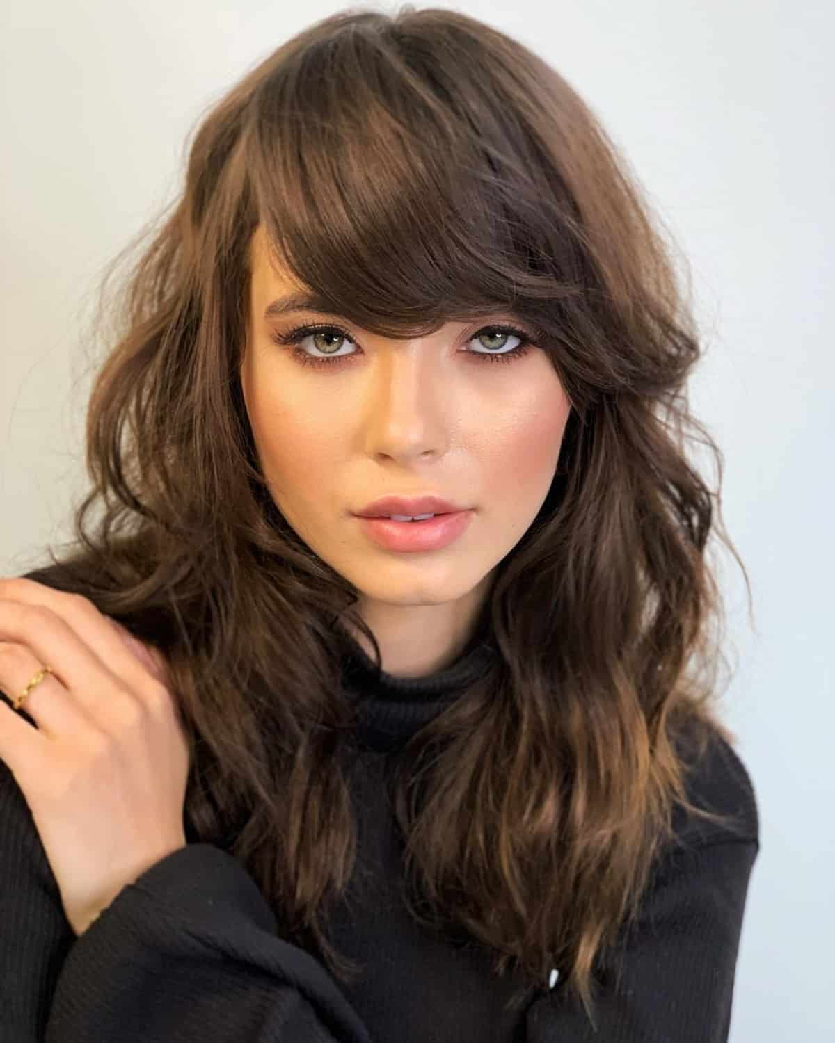 Shaggy Medium-Length Haircut with Sweeping Side Bangs for Square Faces