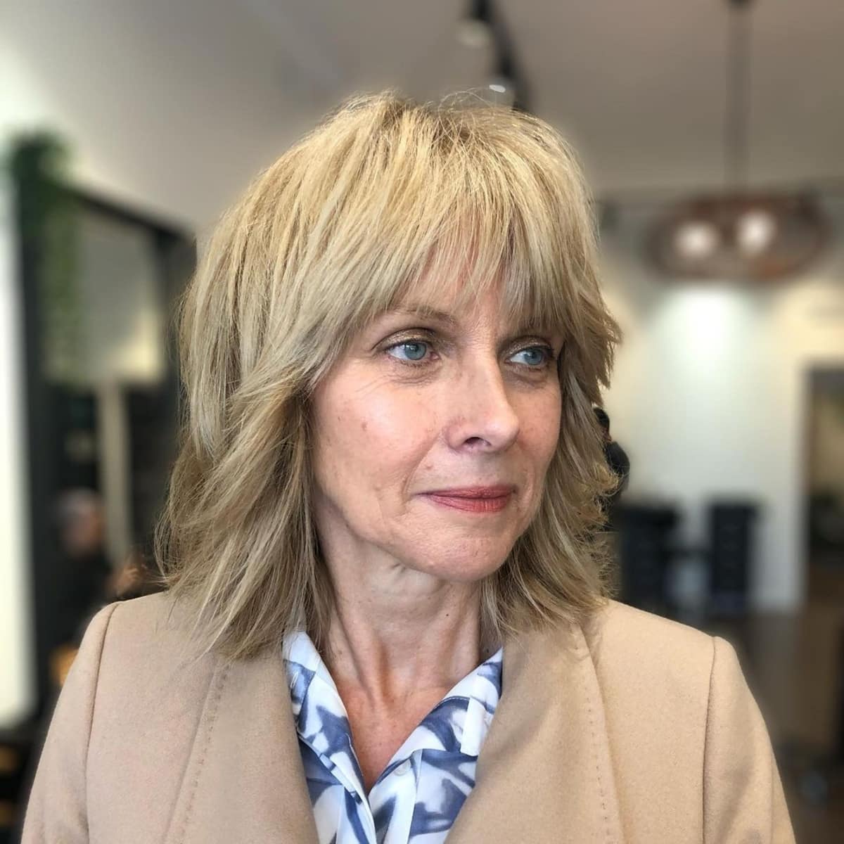 Medium-length hairstyle with bangs and layers for women over 60