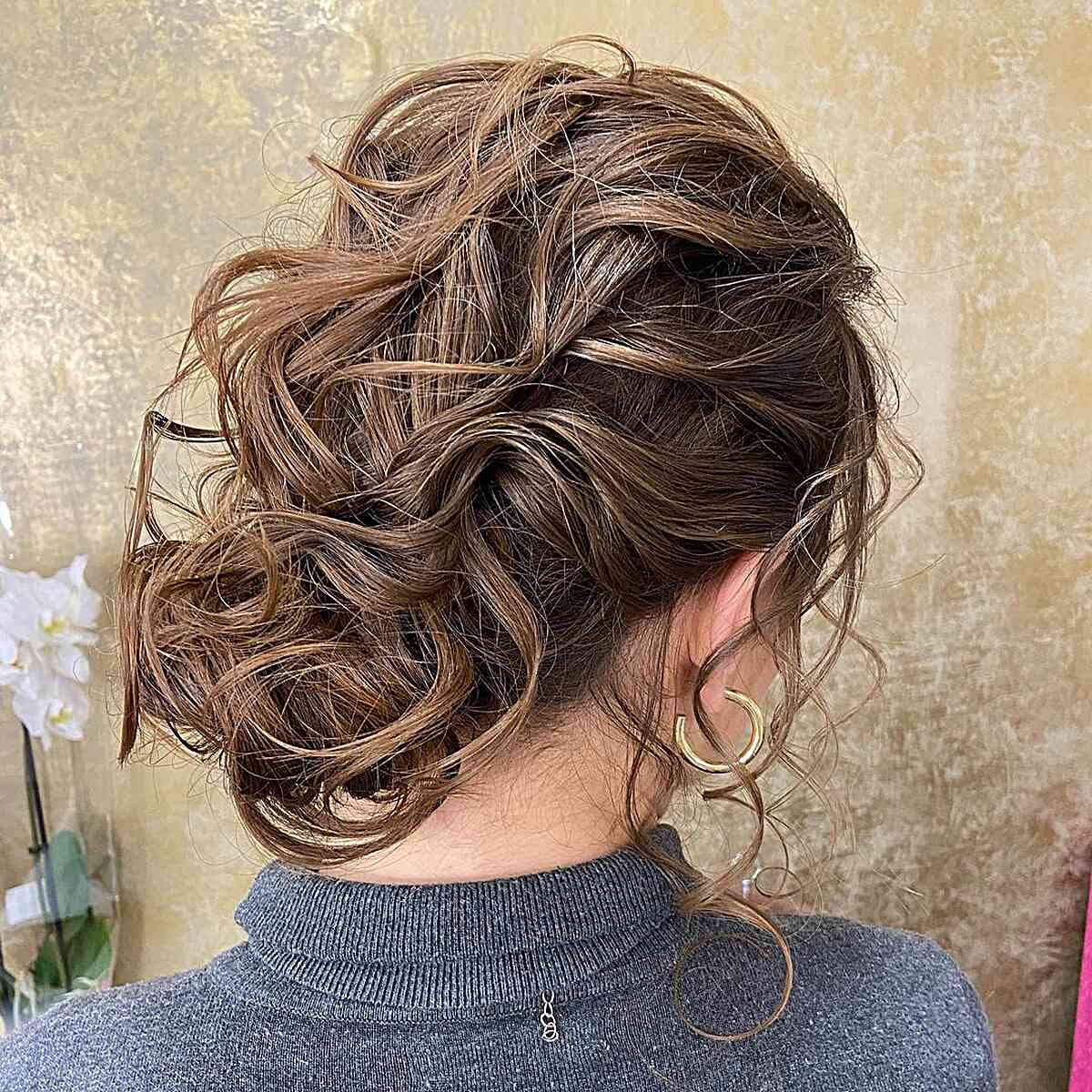 Medium-Length Messy Low Bun with Piece-y Waves for Prom