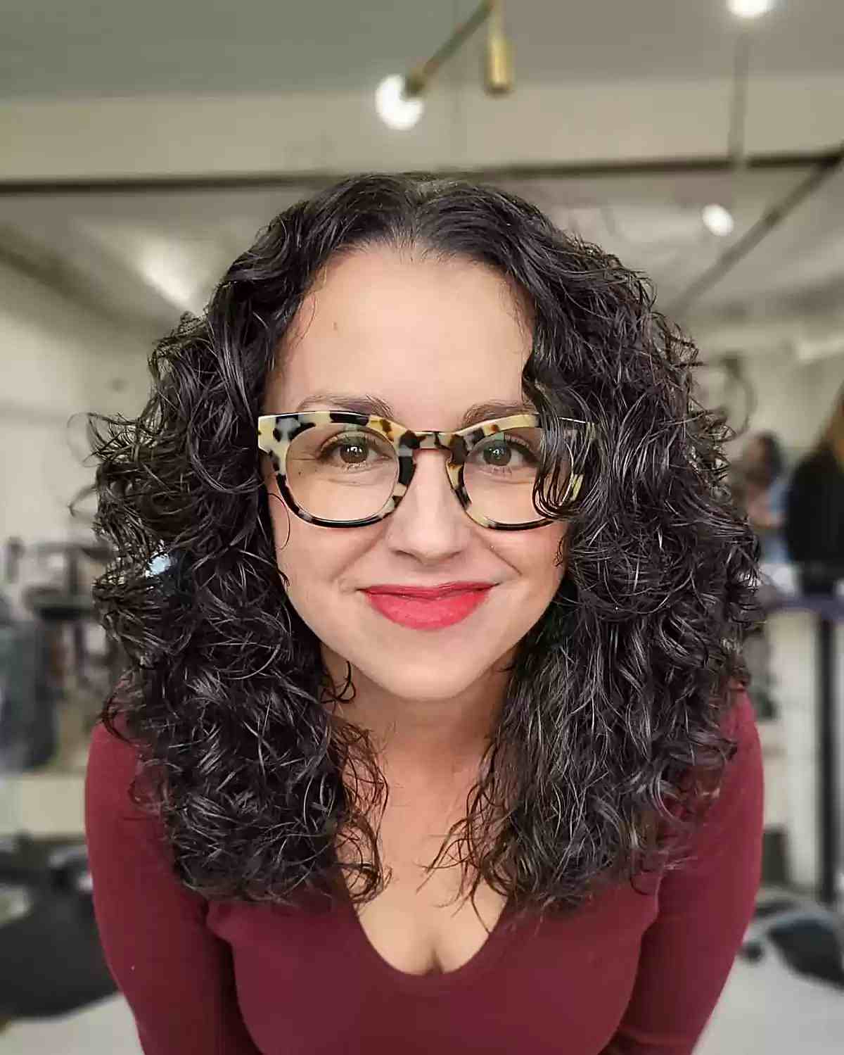 Medium-Length Type 3 Curly Shag for Older women with salt and pepper hair with glasses