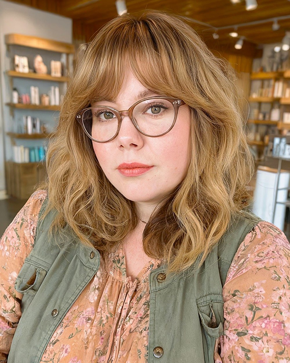 Medium shag haircut with curtain bangs and tousled texture for round faces over 40