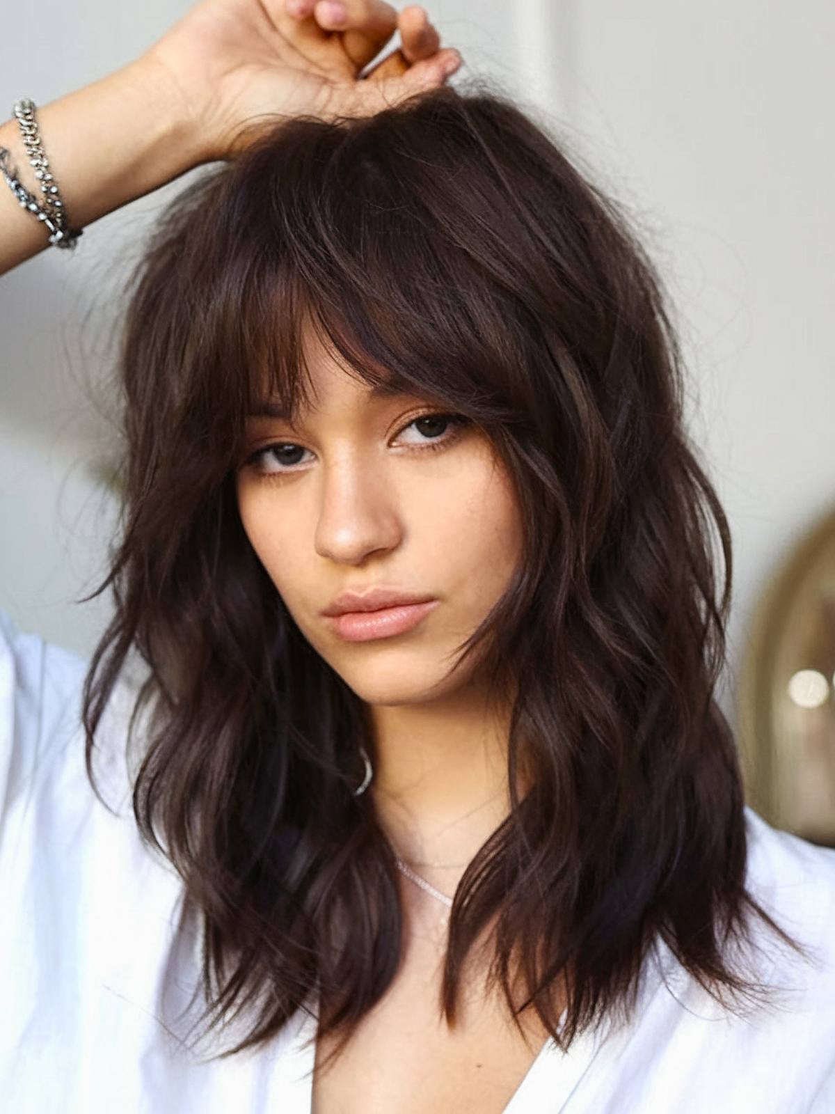 Medium shag haircut with waves and bangs for thick hair