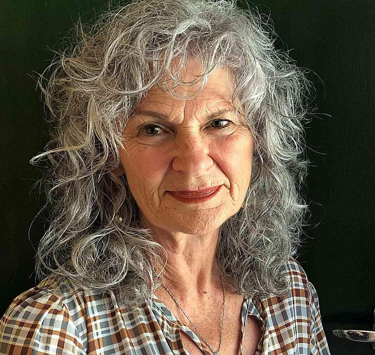 Messy and Frizzy Curly Shag with bangs for Ladies in their 60s with shoulder-length hair