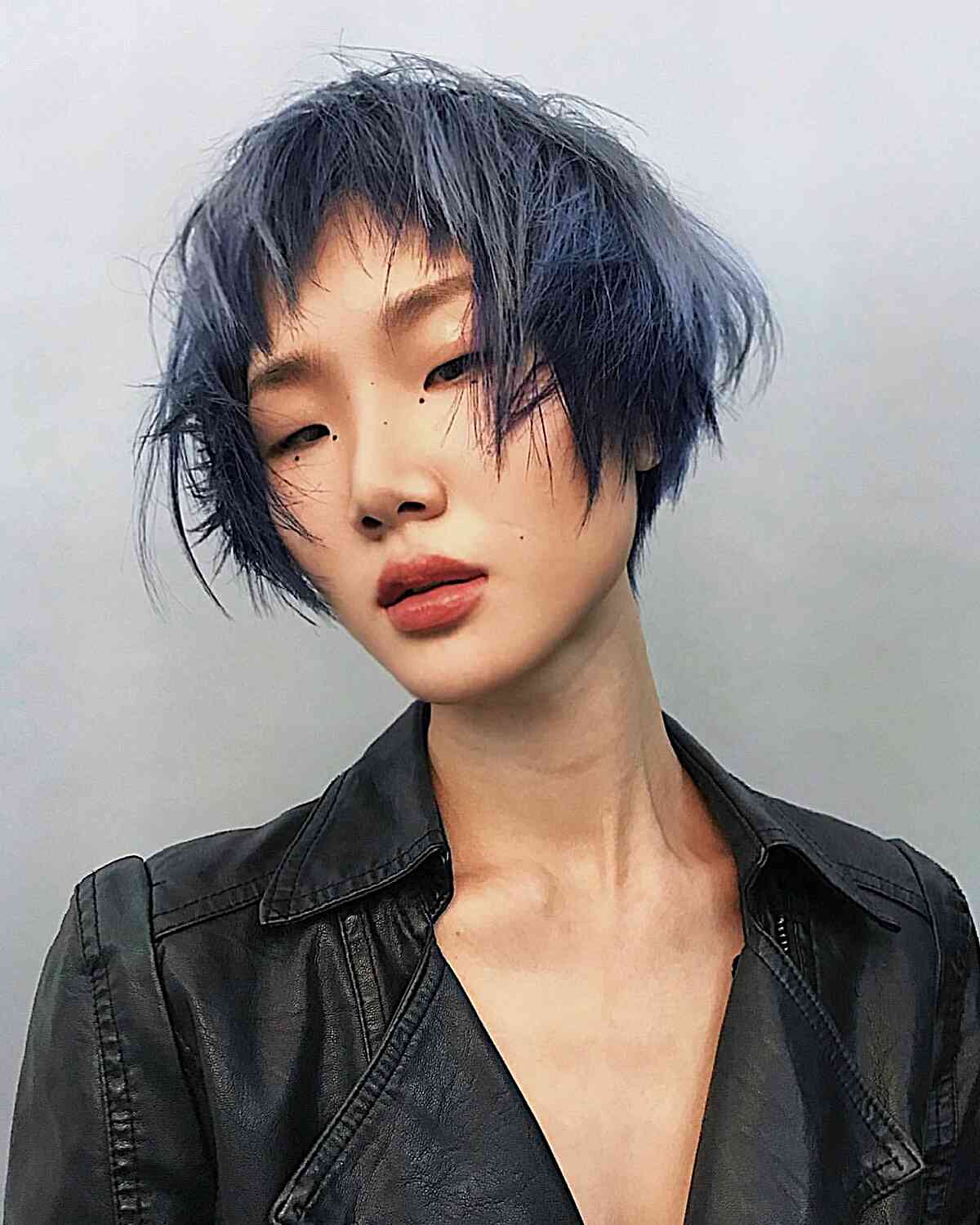 Messy Bixie with Razored Layers on Jaw-Length Choppy Hair with Dark Blue Color
