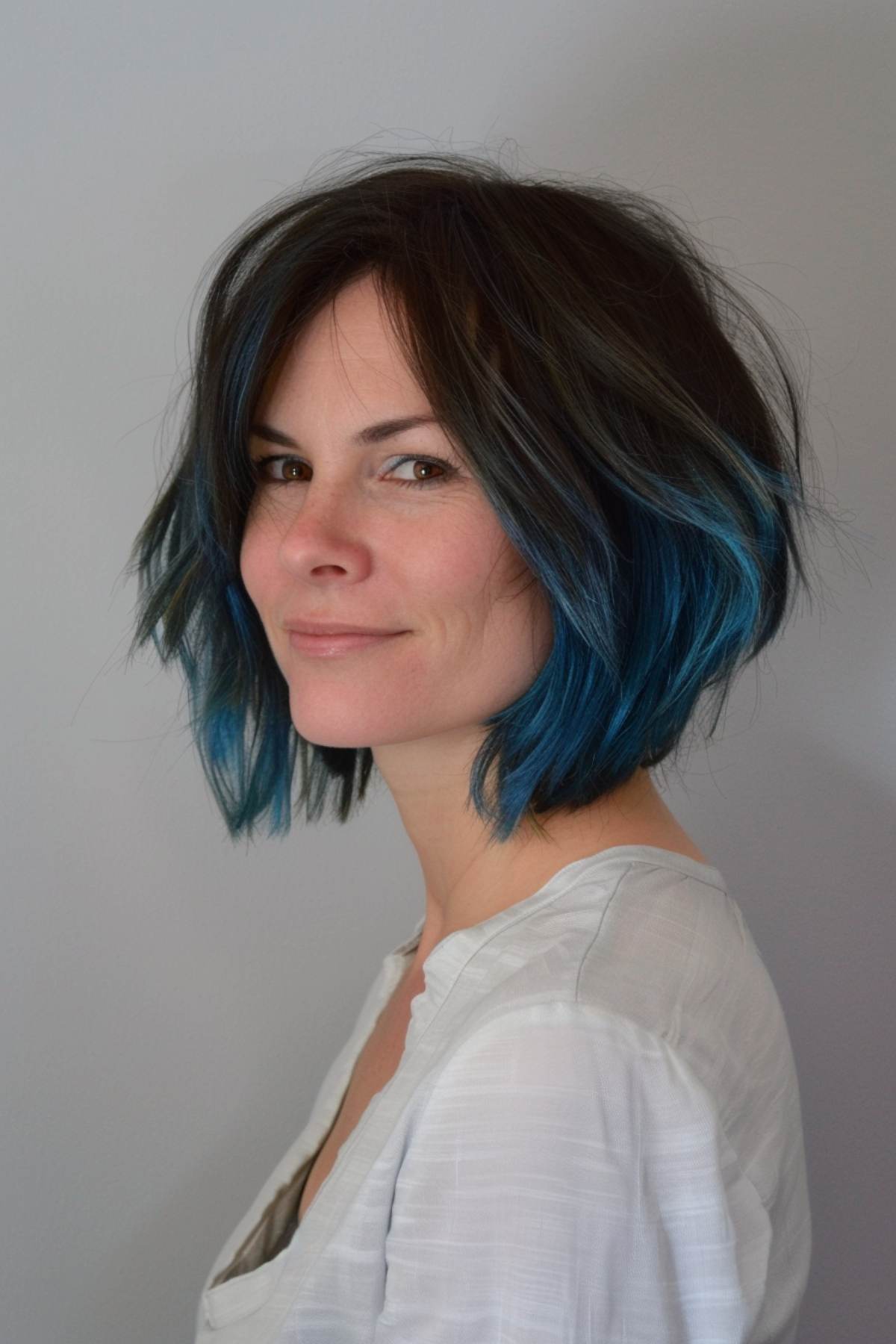 Messy bob with blue highlights and tousled layers