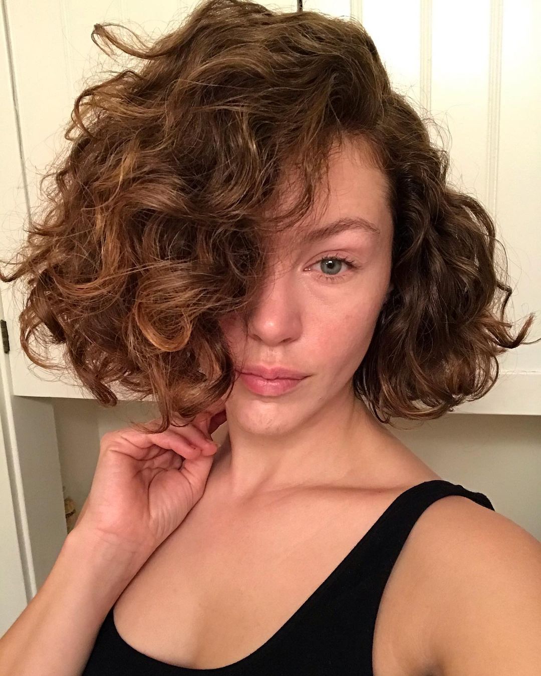Messy curly bob with a side part