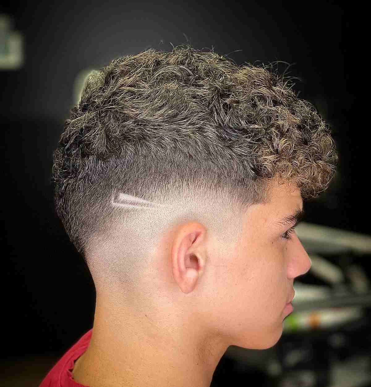 Messy Drop Fade Wavy Top with a Shaved Design for Guys