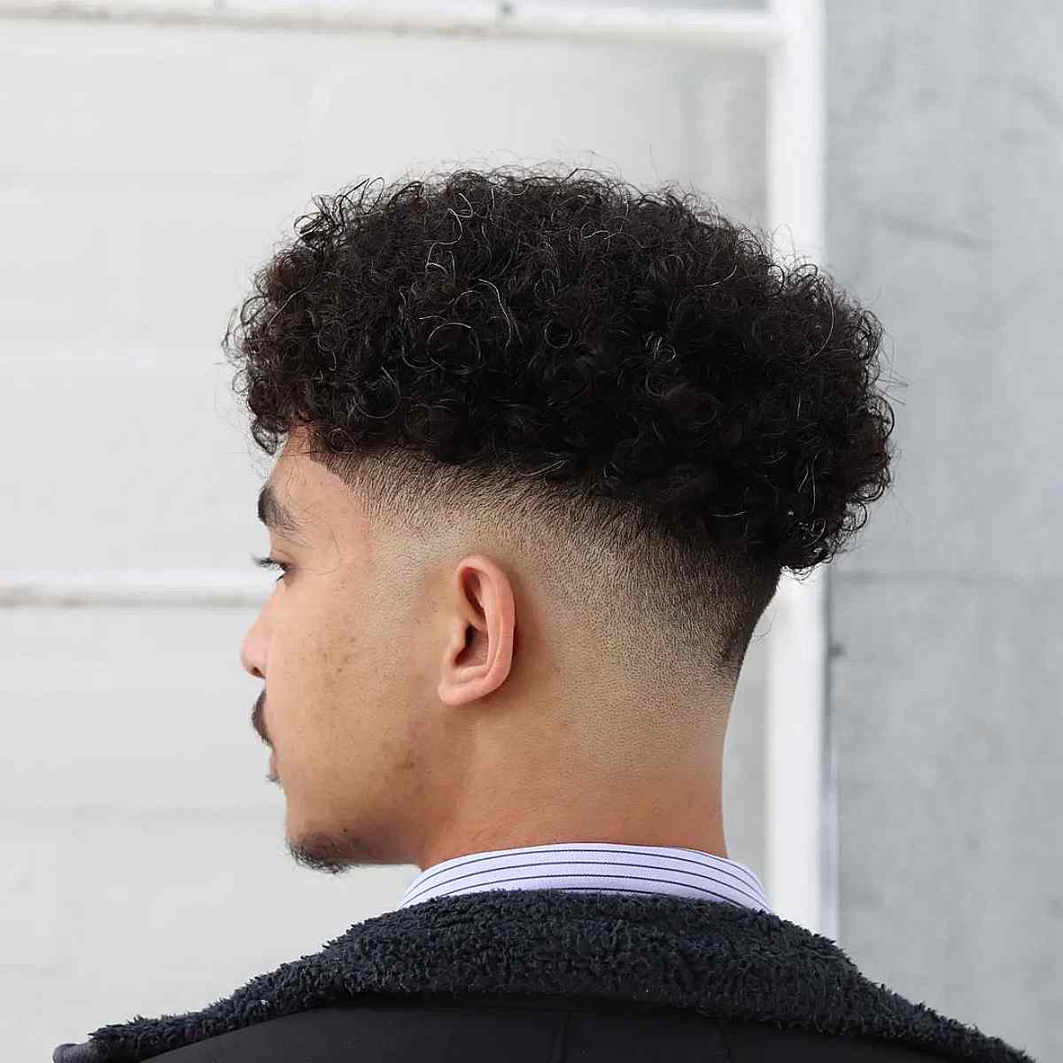 Messy Low Curly Fade Style for Men