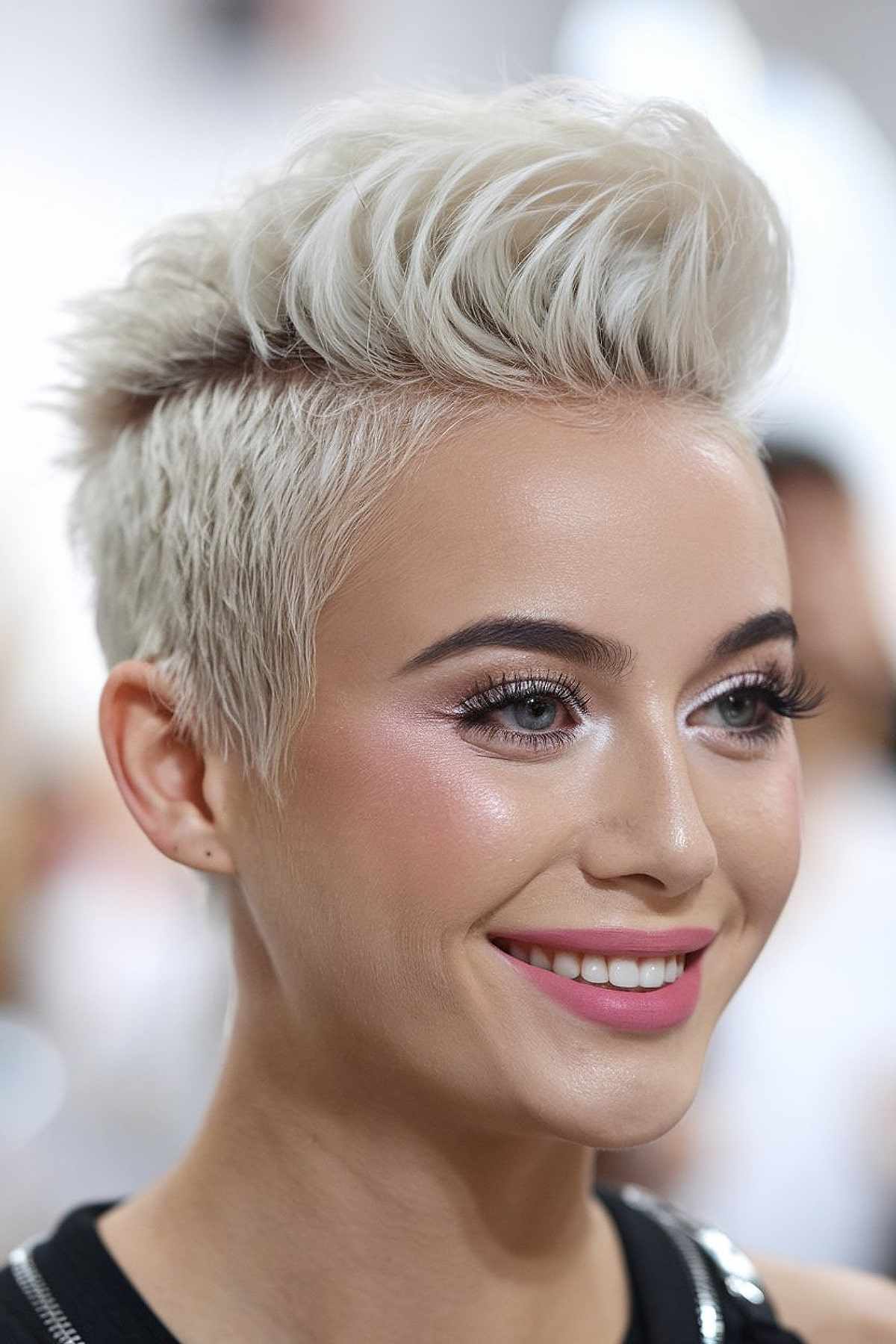 Messy quiff hairstyle with platinum blonde color and textured top for added volume