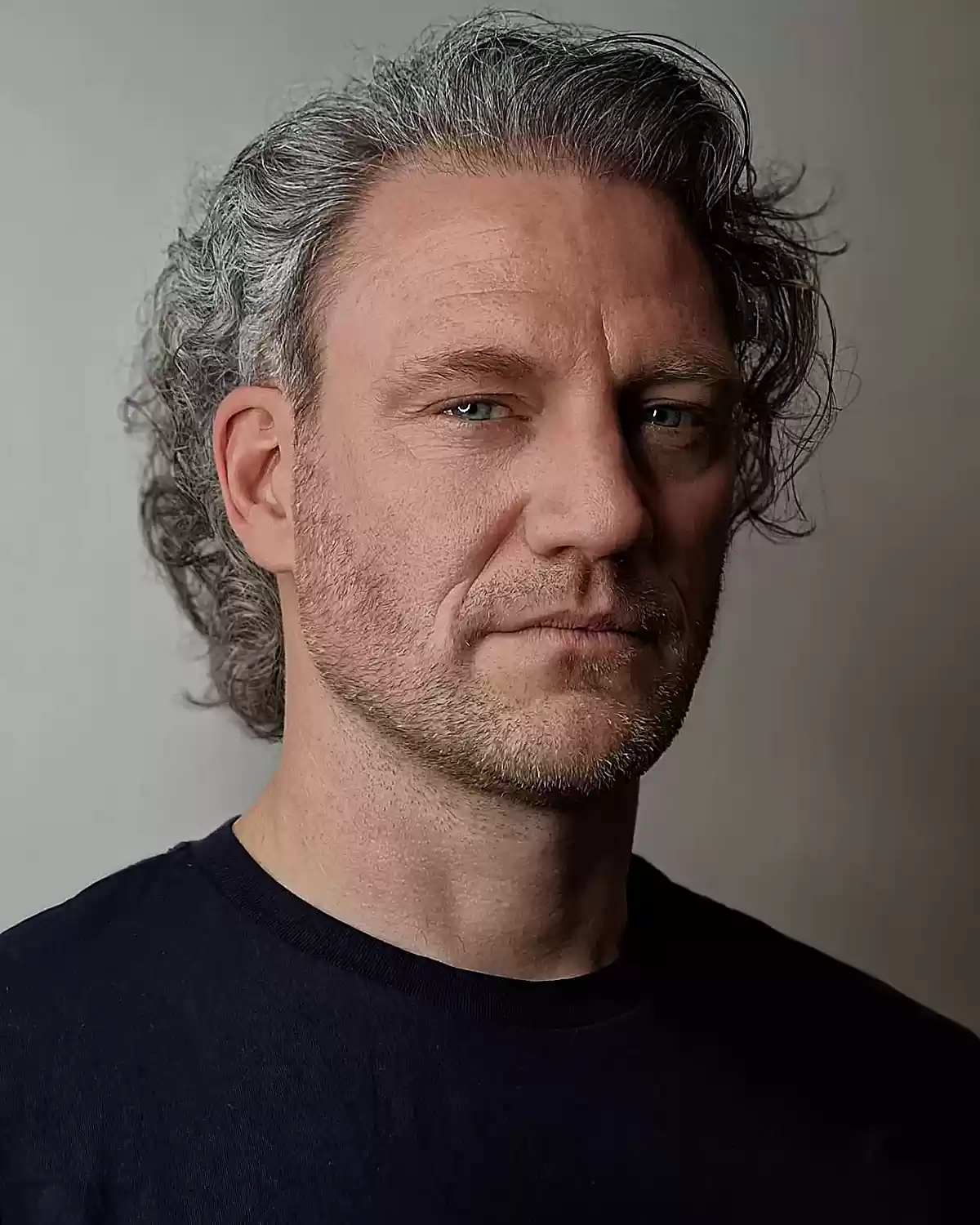 Messy silver locks for men with mid-length hair and a scruffy beard