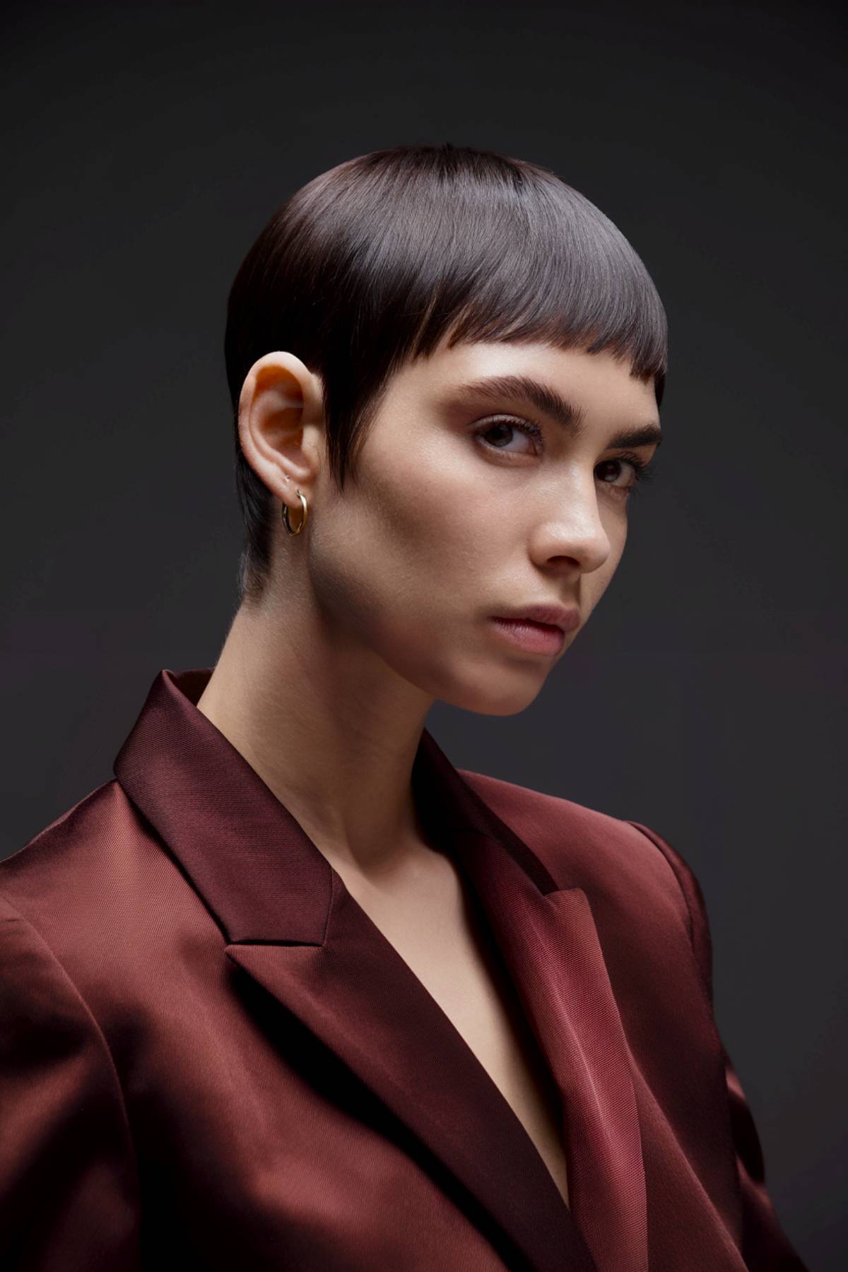 Sleek microchic pixie with ultra-short fringe and precise lines for a bold, modern edge