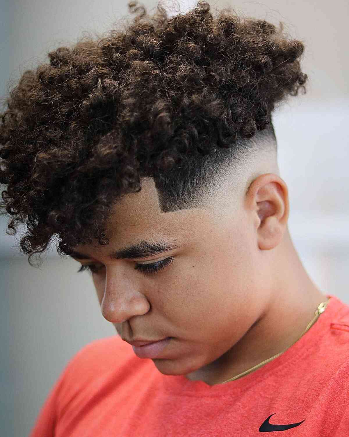 Mid Bald Fade Cut with a Curly Top for Teen Boys