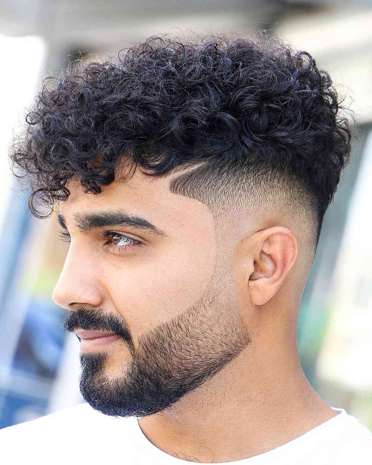 mid fade short curly hair with surgical line designs