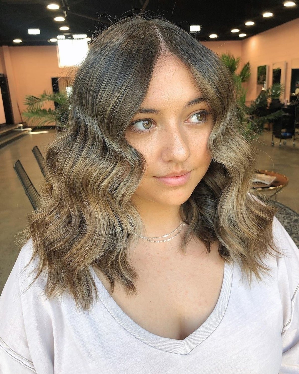 Mid-Length Beach Waves with a Center Part for a Round Face