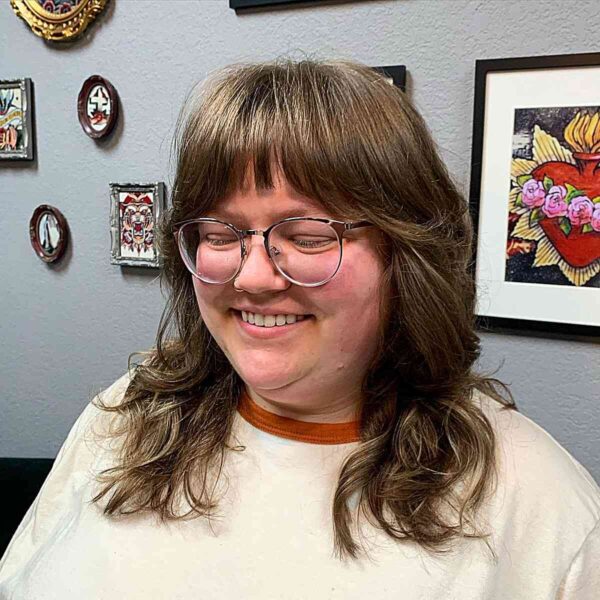 A Mid-Length Brunette Shag with Light Bangs for Plus Size Women