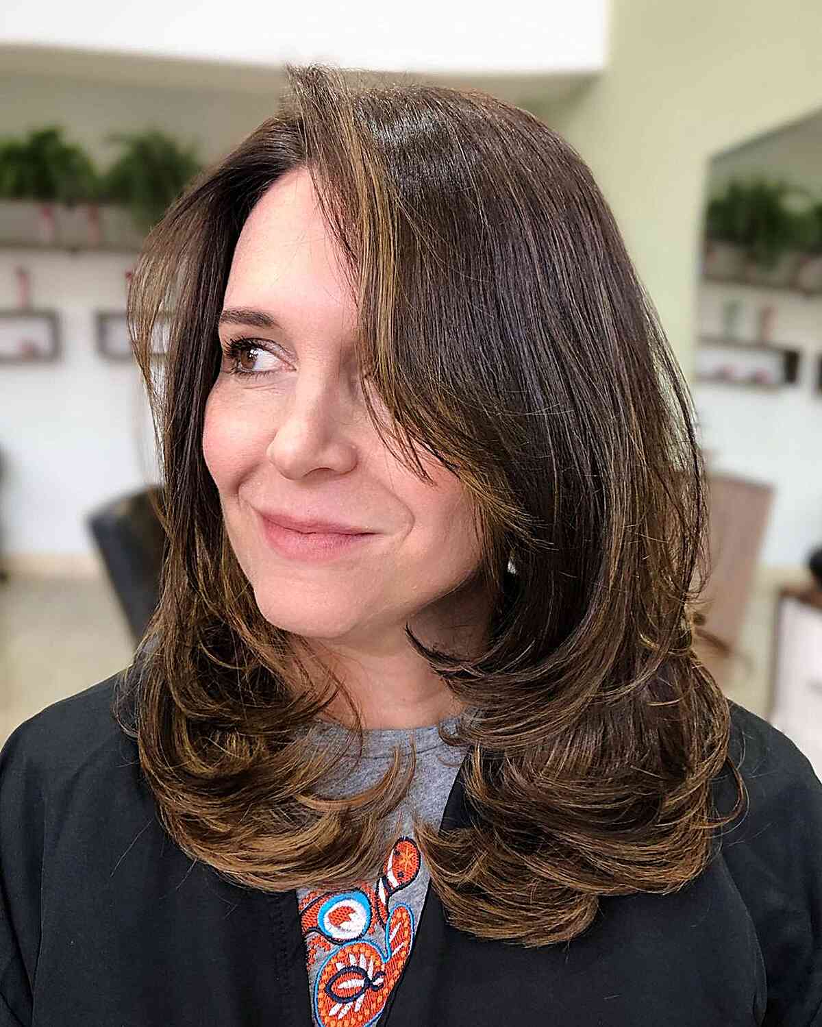 Mid-Length Butterfly Layered Hair with Long Bangs for Older Women