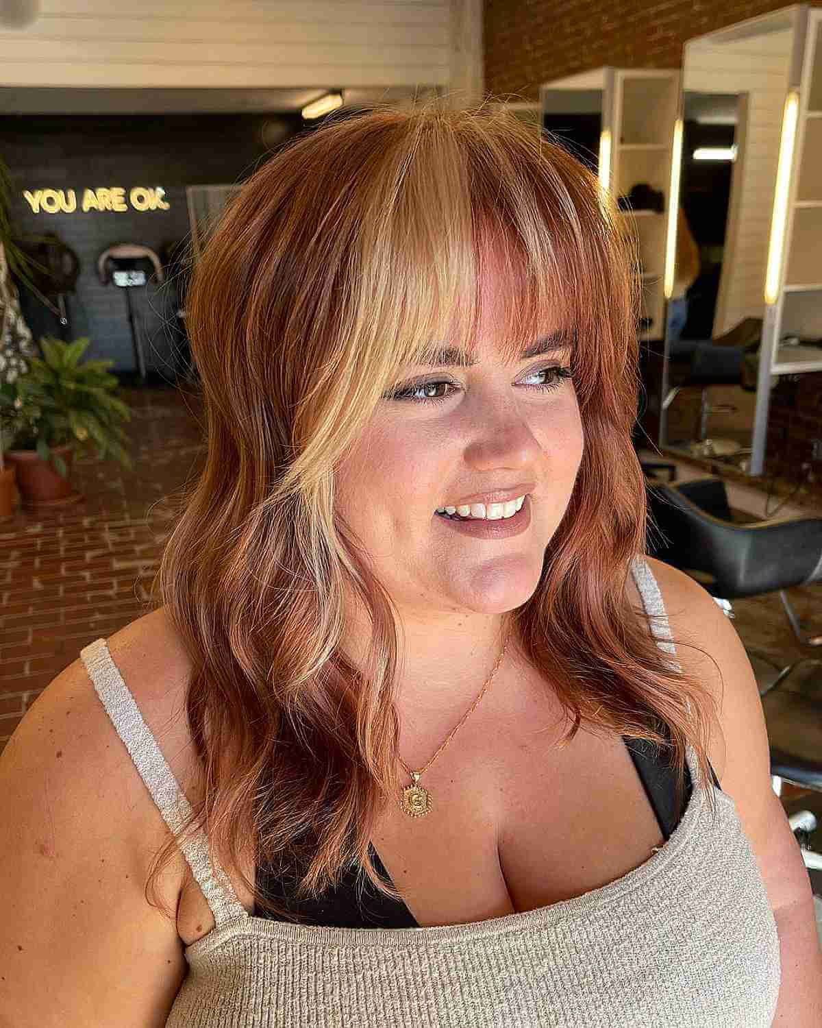 Mid-Length Copper Wavy Hair with Pops of Blonde for a Round Face