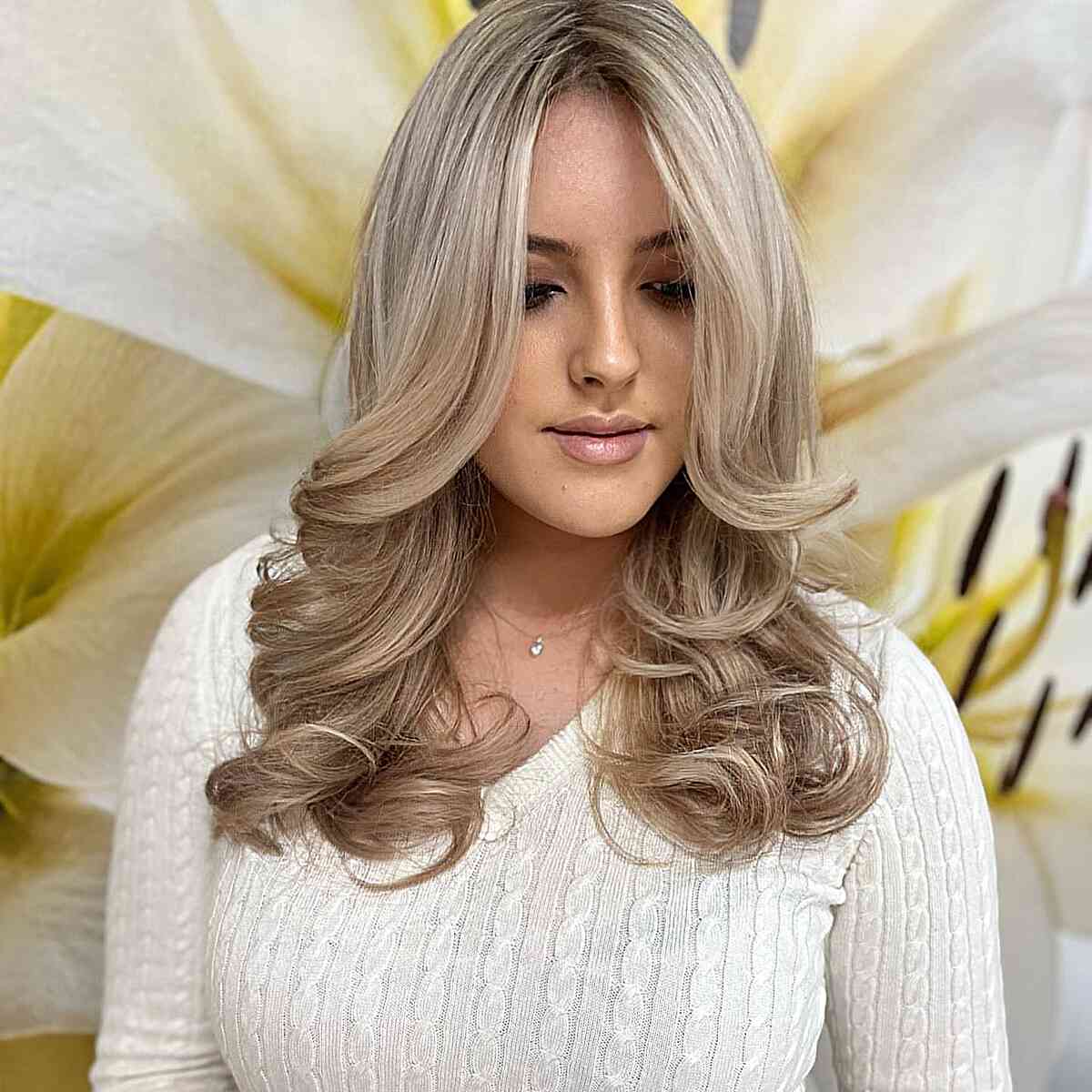 Mid-Length Creamy Light Blonde with long curtain bangs and a middle part
