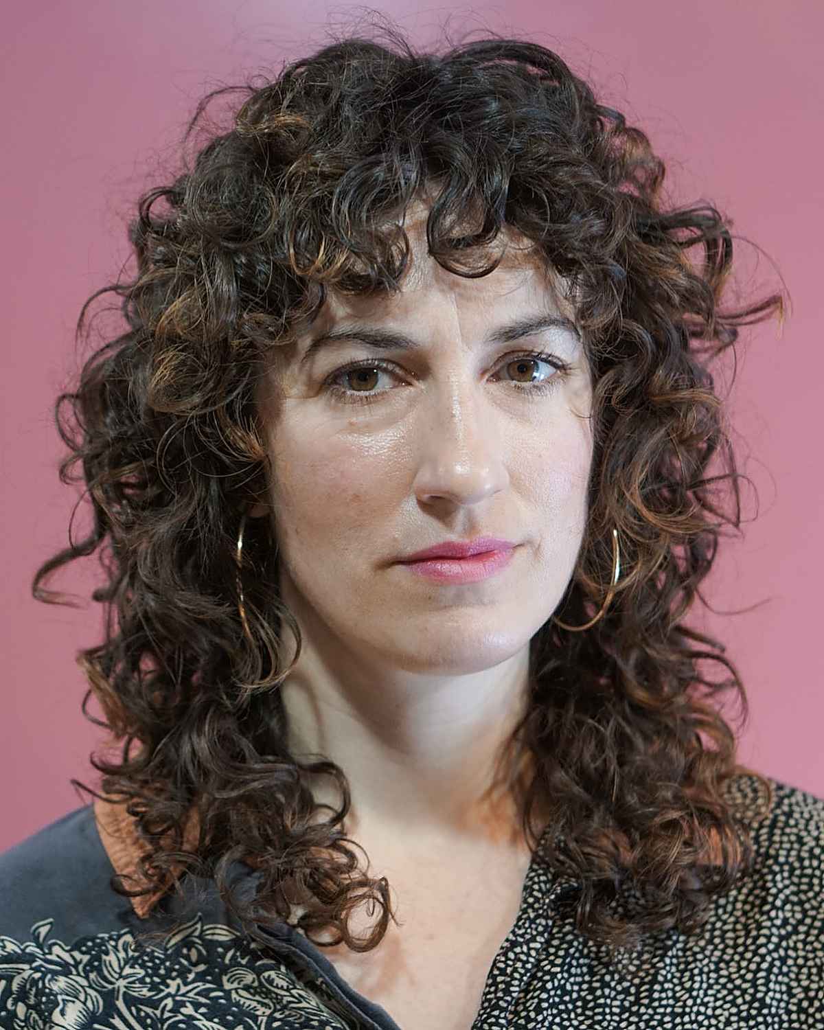 mid-length curly shag cut with curly bangs