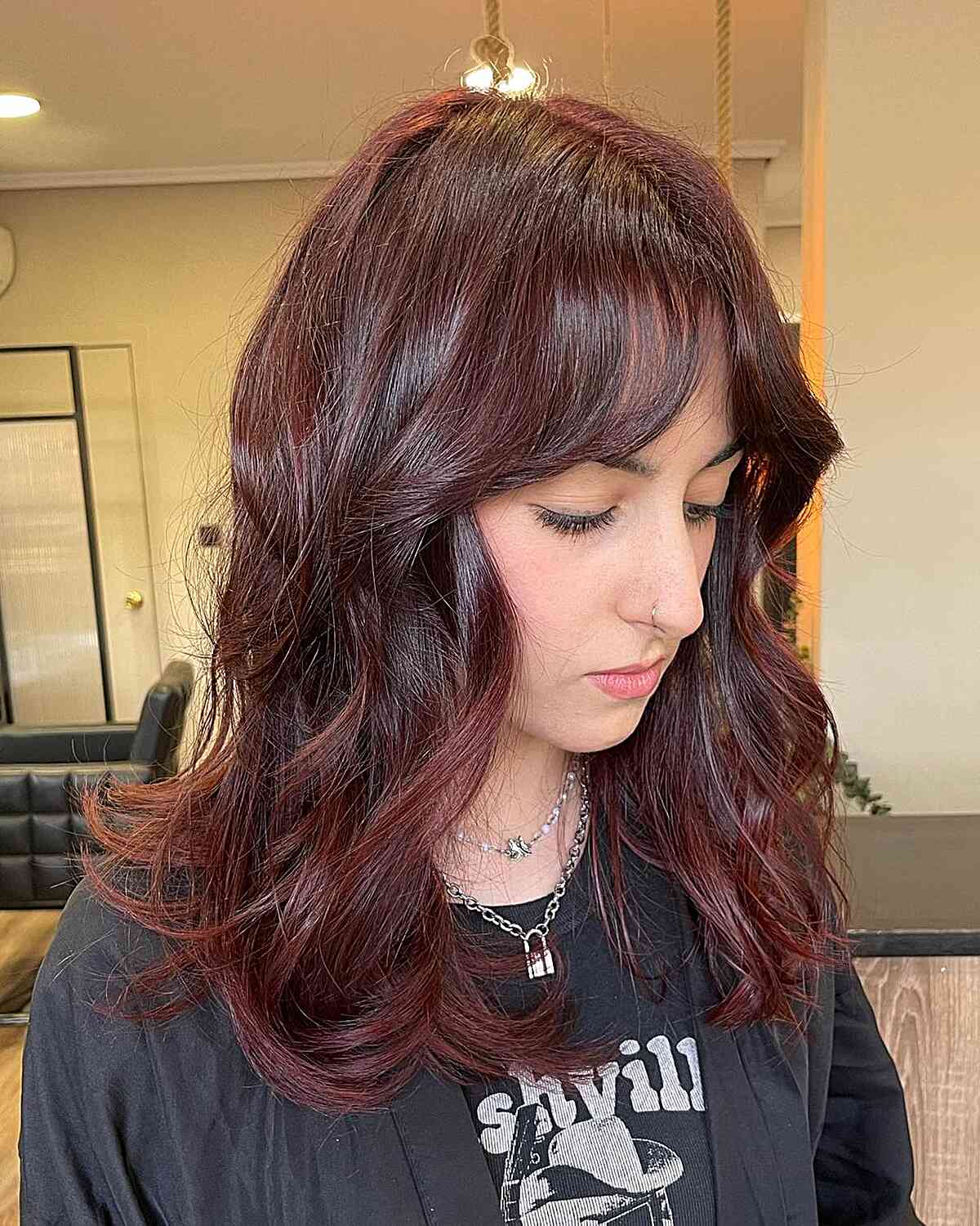 Mid-Length Layers and Curtain Bangs with Burgundy Mahogany Hair Color