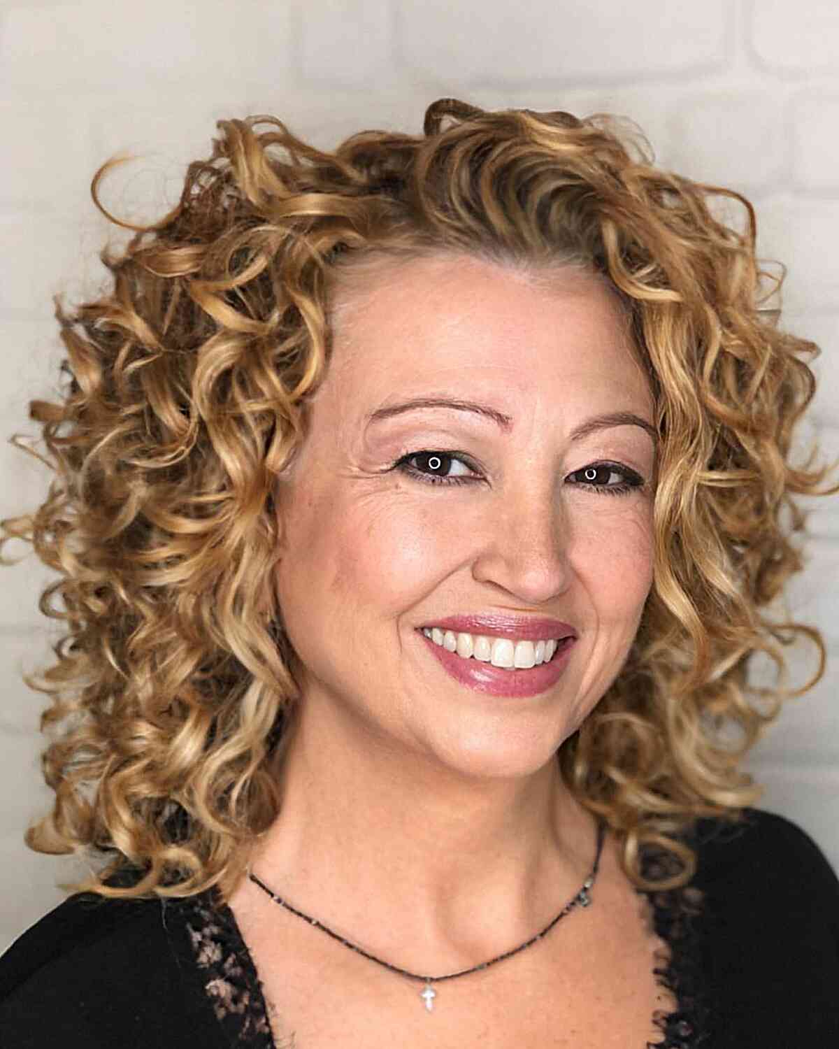 Mid-Length Loose Blonde Curls for Ladies Aged 50