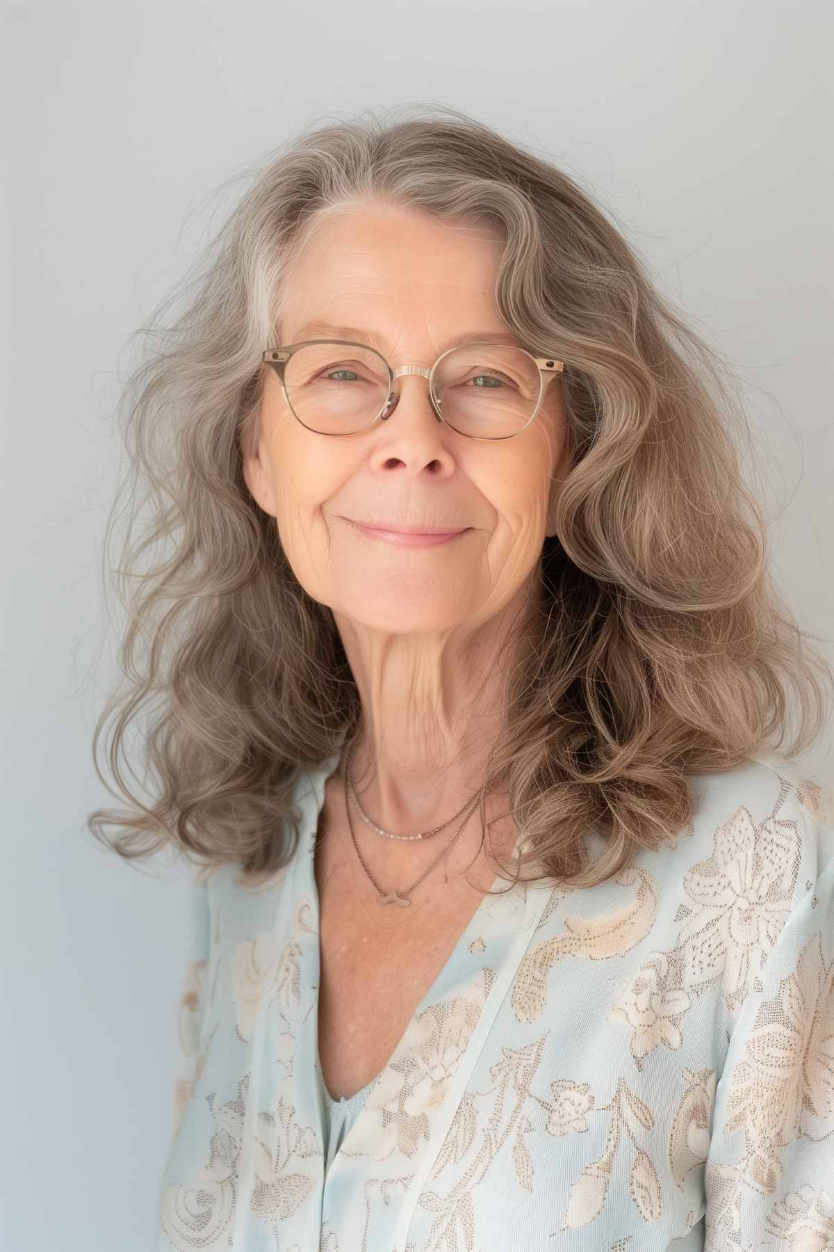 Mid-length shag haircut with soft waves on a woman wearing glasses