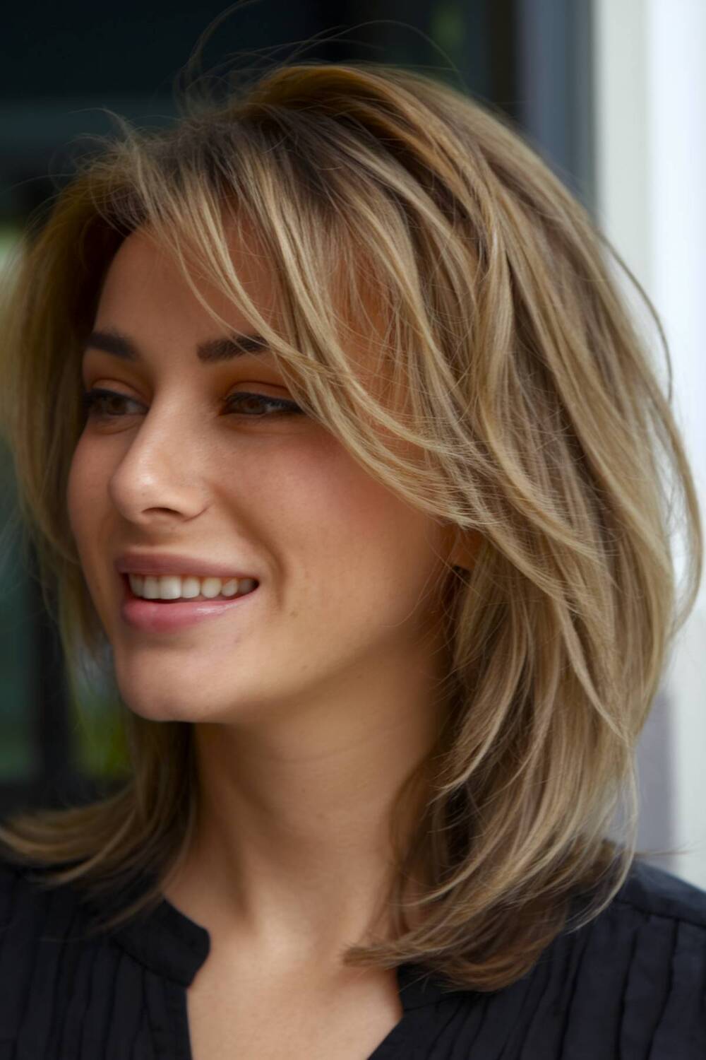 Mid-length shoulder cut with blended layers for effortless movement and a natural finish