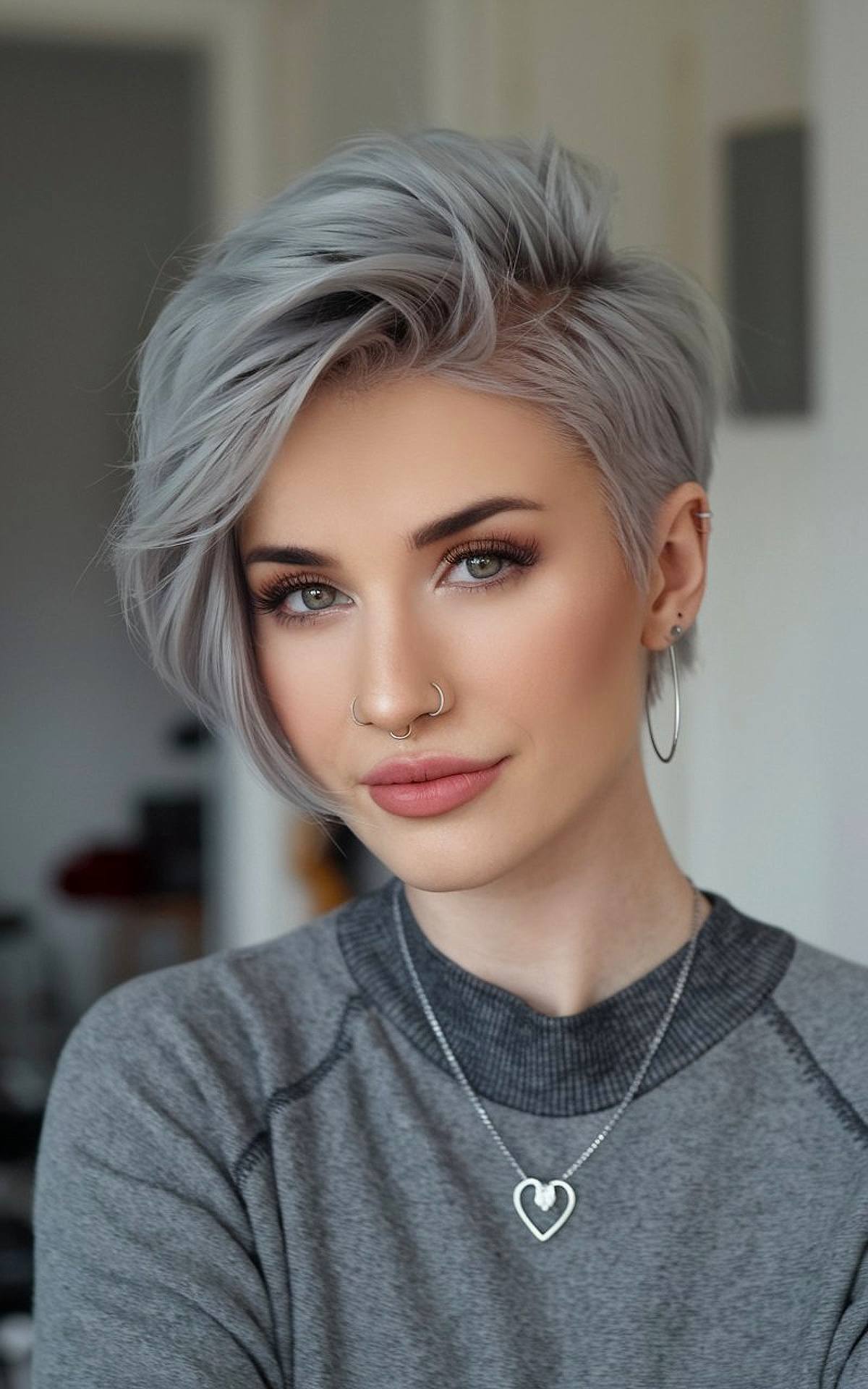 Silver pixie cut with long side-swept fringe and undercut for a bold, modern look